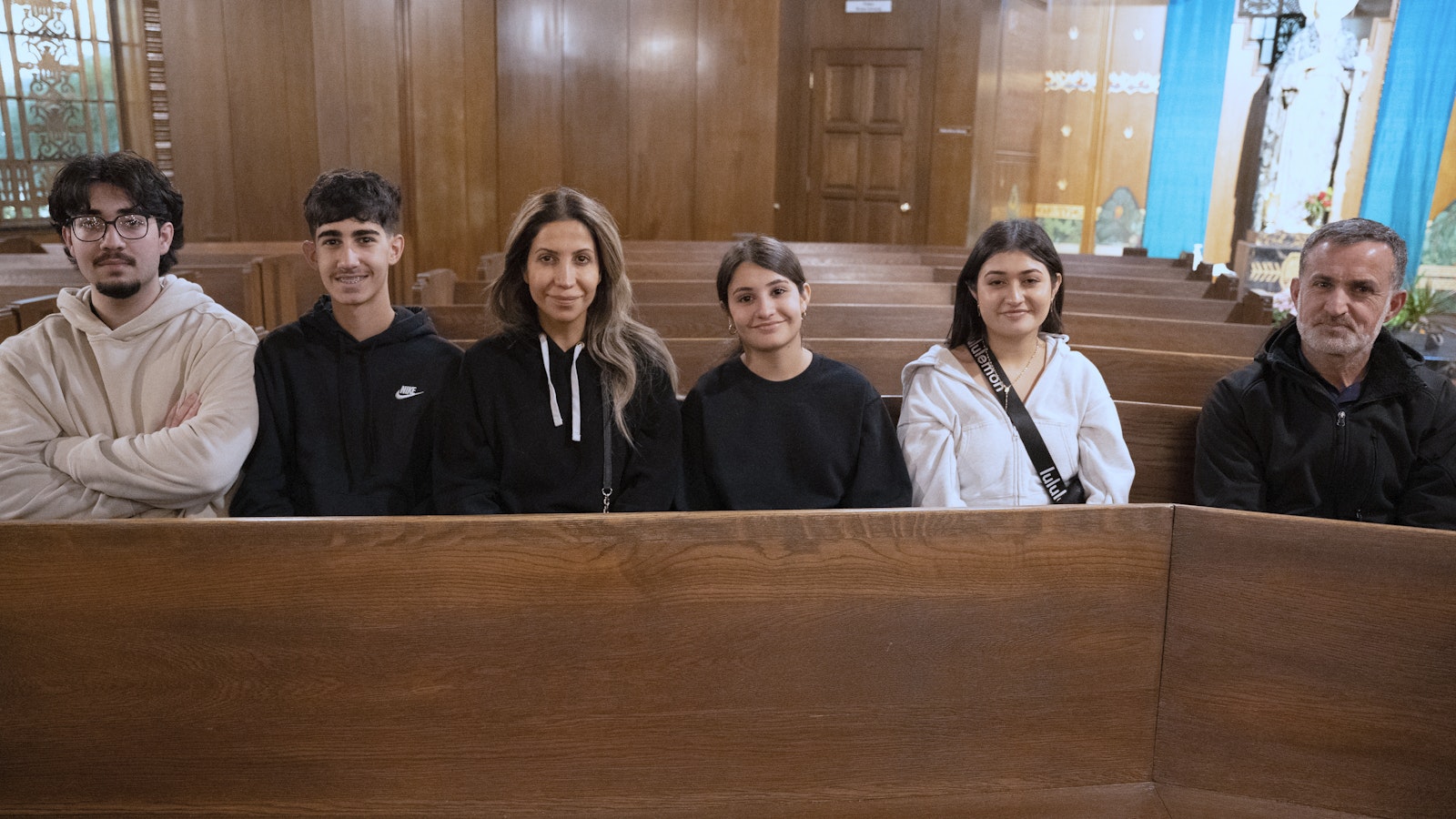 Linda Kanna, third left, sits with her family after venerating the relic of St. Jude on Oct. 13. Her son Jude is far left.