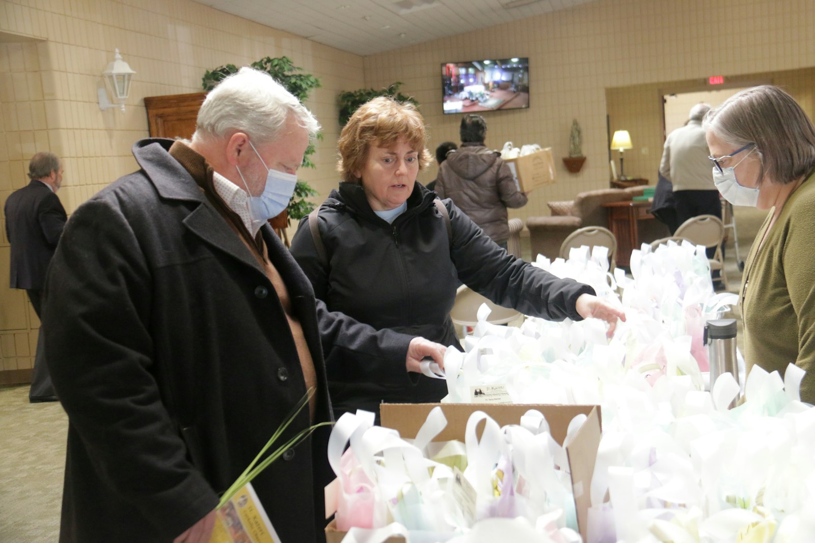 St. Kateri parishioners pick up Easter bags to deliver to elderly parishioners after Mass on Palm Sunday, April 10. The parish started the outreach program during the pandemic, but decided to continue to let senior members of the parish know they're still a valued part of the parish community.