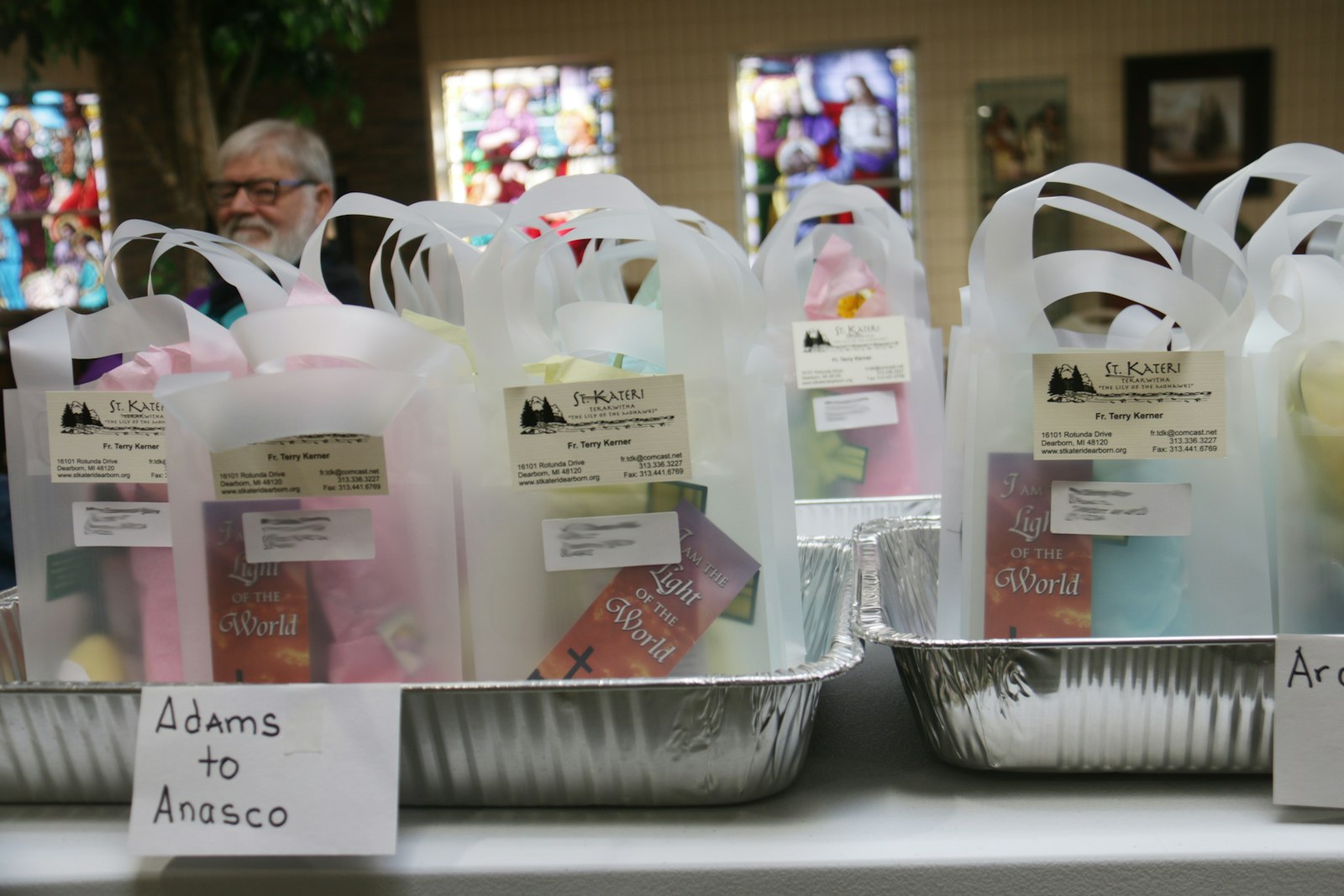 Easter gift bags contained blessed palms, prayer beads, plastic Easter eggs filled with well-wishes, prayer cards and some artificial flowers (photo edited to blur names and addresses).