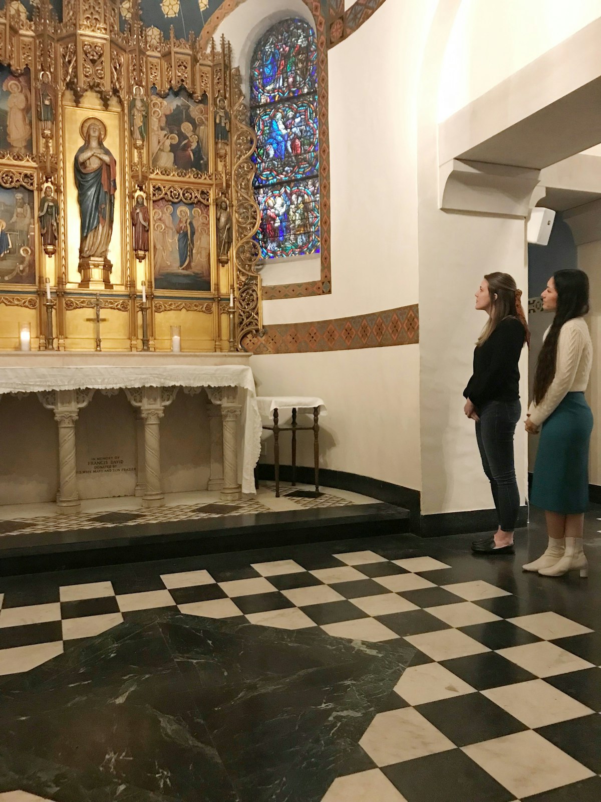 Missionaries serving at St. Mary of Redford Parish in Detroit pray before an altar in the church in this file photo. "Once the (former school) building is sold, my role shifts to collaboration as a neighbor," Fr. Fornwalt said. "I know at St. Mary’s we have one of the most beautiful churches in the archdiocese, even in the country. As far as being able to offer a place of peace, of prayer, beauty, of transcendence, our doors are always open. That’s absolutely something we bring to the city, our neighborhood, and our neighbors who live in these buildings." (Photo by Kelly Luttinen | Special to Detroit Catholic)