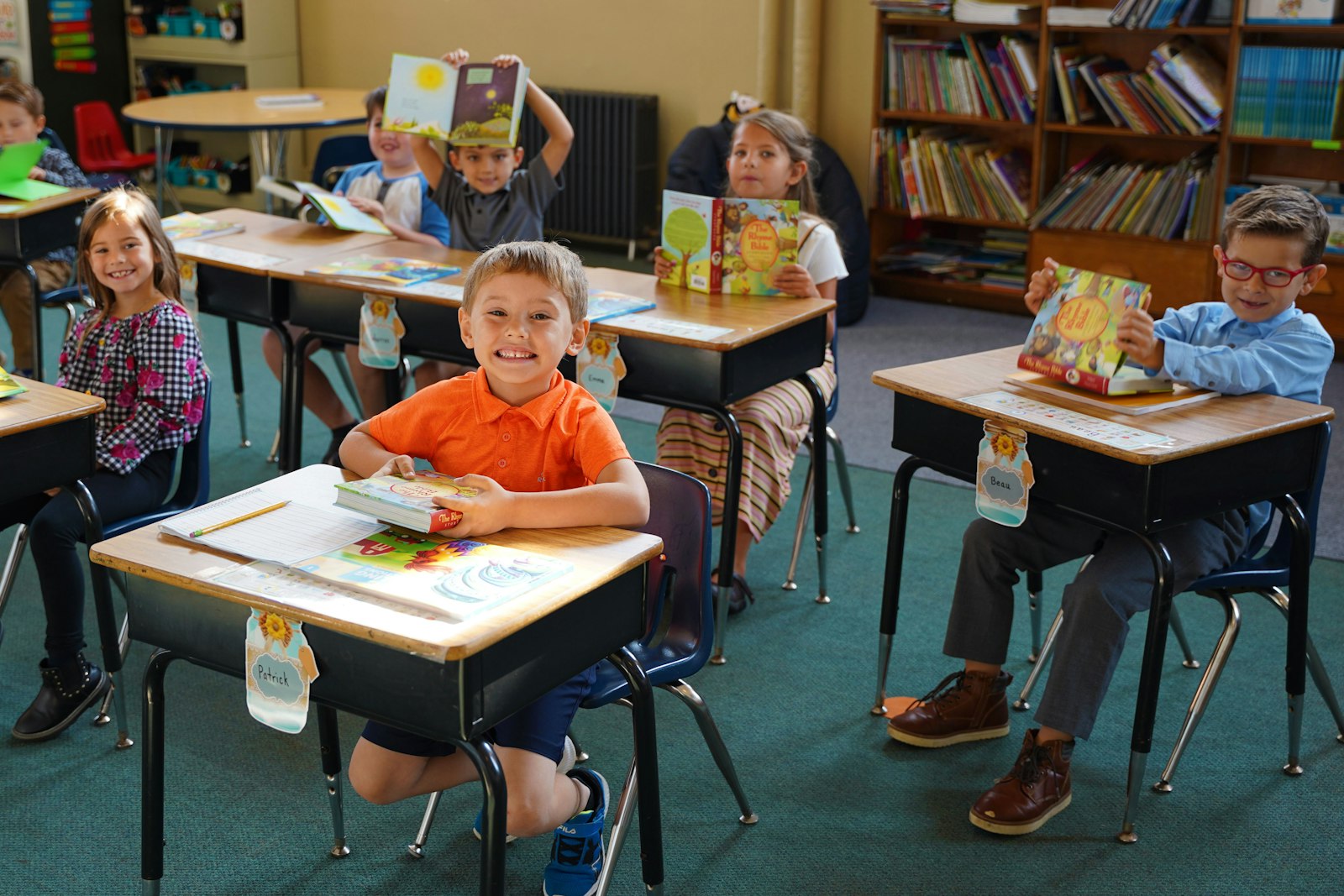 First graders at St. Patrick School in Carleton hold up their "Rhyme Bibles" for the camera while dressed for picture day.