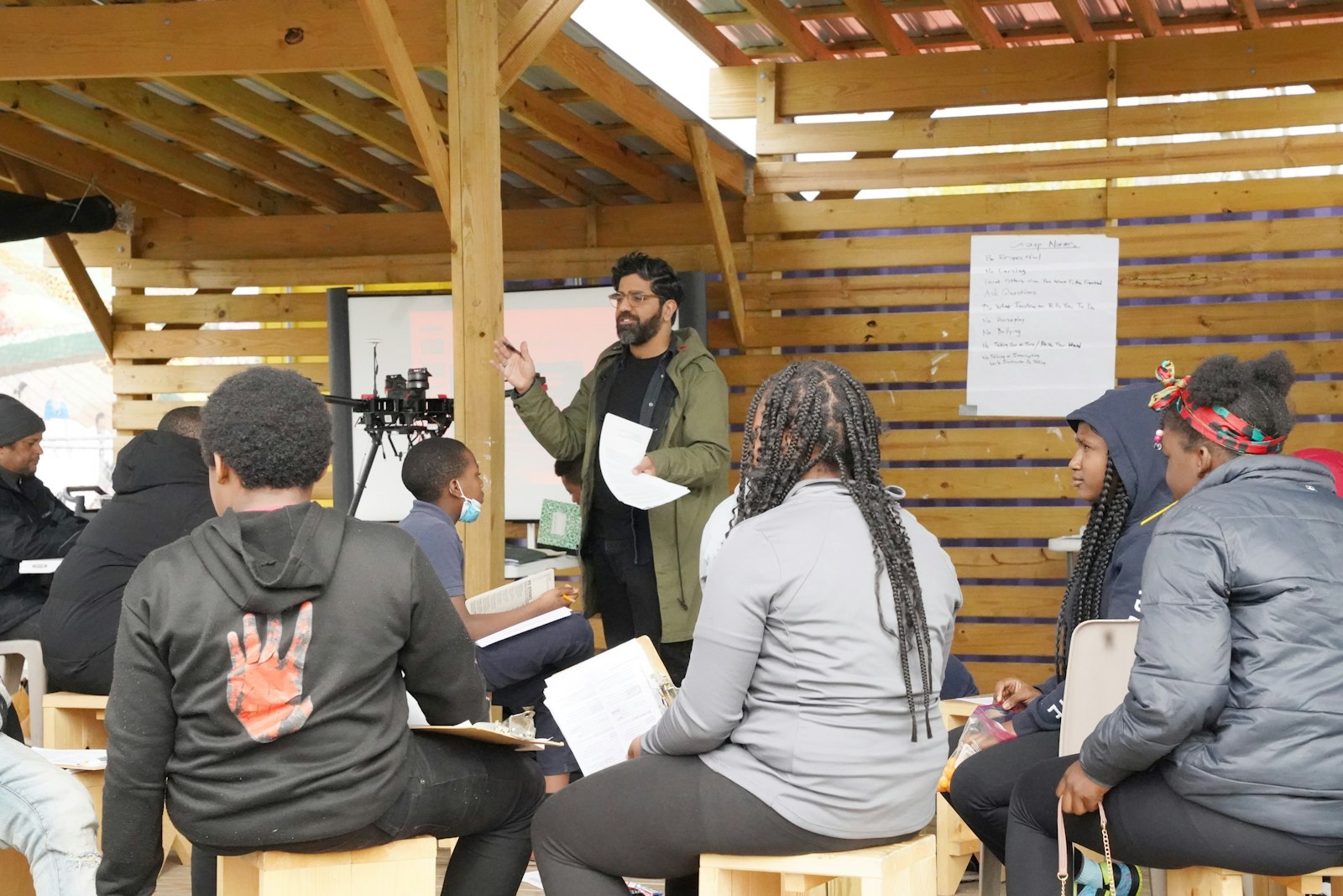 Fareed Sajan, an instructor of the St. Suzanne Cody Rouge Community Resource Center’s after-school STEAM program, gives a lesson on the water cycle in the outdoor classroom constructed in the parking lot behind St. Suzanne/Our Lady Gate of Heaven Parish.