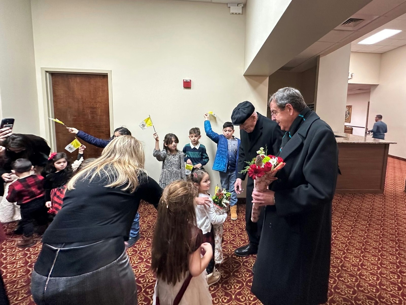 Children greet Detroit Archbishop Allen H. Vigneron, right, during a visit to St. Toma Syriac Catholic Cathedral on Dec. 8, 2022. (Courtesy of St. Toma Syriac Catholic Cathedral)