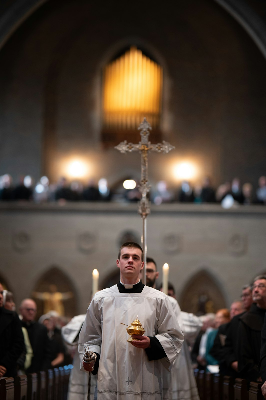 Seminarians carry a crucifix into the chapel during the opening procession. (Tim Fuller | Special to Detroit Catholic)