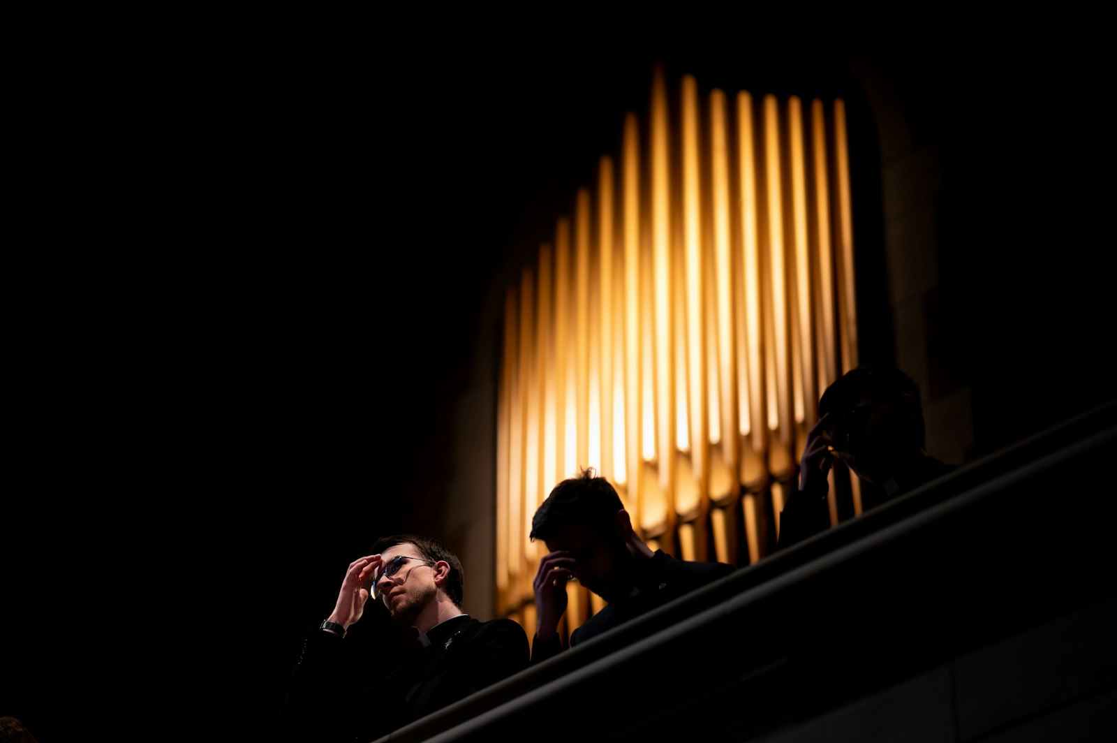 Those seated in the choir loft make the sign of the cross during solemn vespers March 17 in Sacred Heart's chapel. (Tim Fuller | Special to Detroit Catholic)