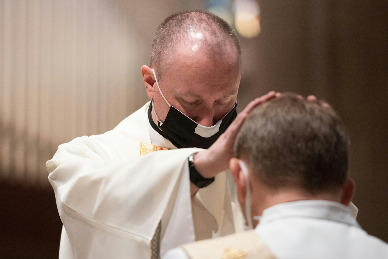 Fr. Andrew Dawson blesses Fr. John Dudek during Fr. Dudek's ordination Mass in May 2021 at the Cathedral of the Most Blessed Sacrament. Although the priesthood is a vocation of sacrifice, men who are discerning should know the love and support of the faithful they will serve, the archbishop said. (Tim Fuller | Special to Detroit Catholic)