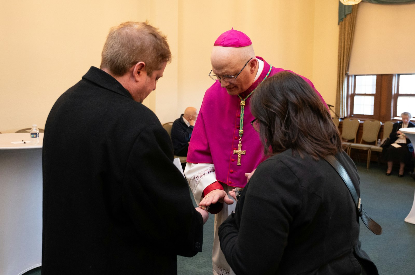 Greeting members of the faithful after the service, Archbishop-designate Weisenburger offers a blessing and prayers. (Tim Fuller | Special to Detroit Catholic)