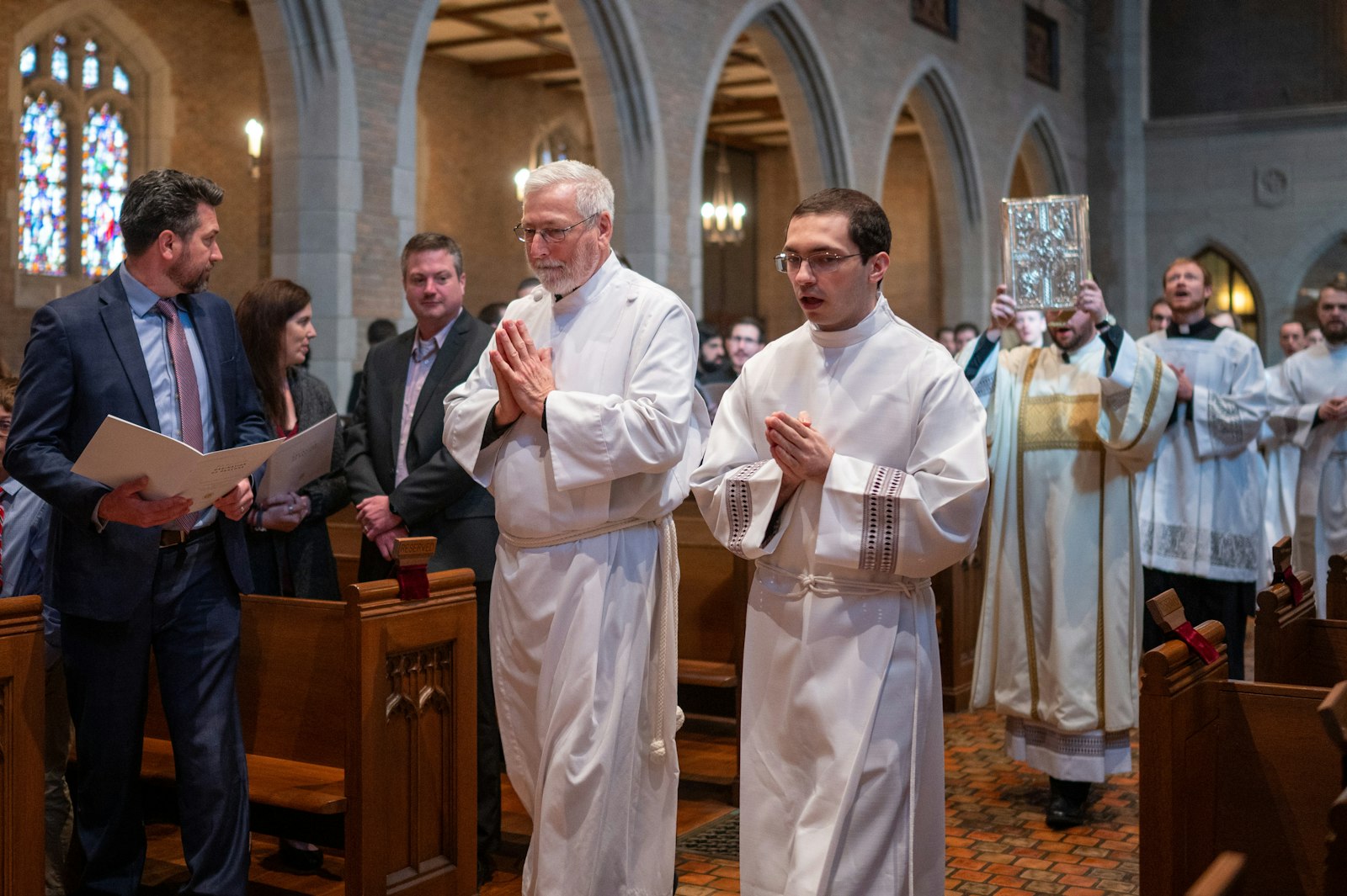 Deacons Bruen, left, and Schroder, right, will spend the next year of their formation ministering at the altar, proclaiming the Word of God, performing baptisms, funerals and weddings, and practicing works of charity, Bishop Cepeda said.