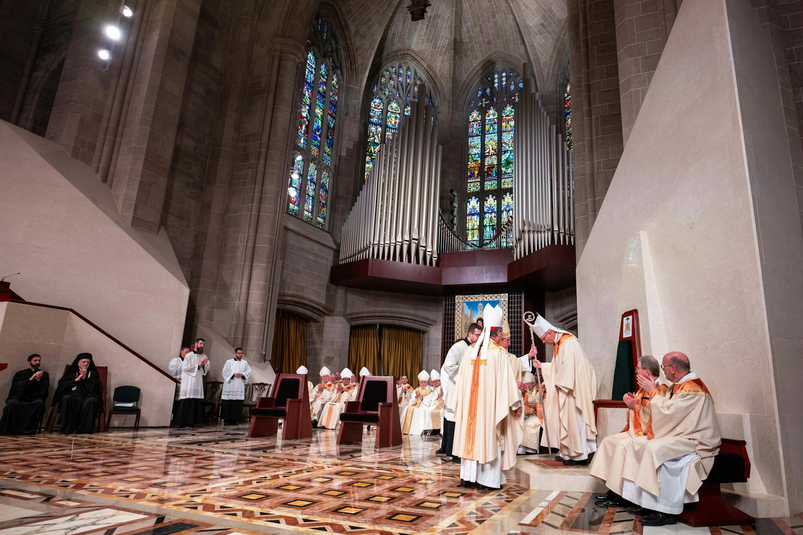 In a moment filled with symbolism and tradition, Archbishop-emeritus Allen H. Vigneron and Cardinal Christophe Pierre, apostolic nuncio to the United States, escort Archbishop Edward J. Weisenburger to his cathedra in the sanctuary of the Cathedral of the Most Blessed Sacrament for the first time during a Mass of installation March 18. (Tim Fuller | Special to Detroit Catholic)