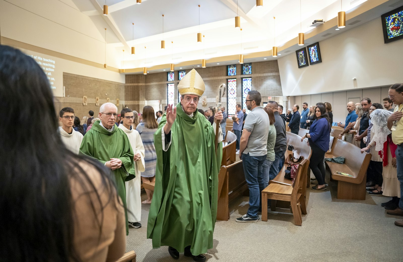 Detroit Archbishop Allen H. Vigneron blesses couples at the end of Mass at St. Therese of Lisieux Parish in Shelby Township to begin the conference.