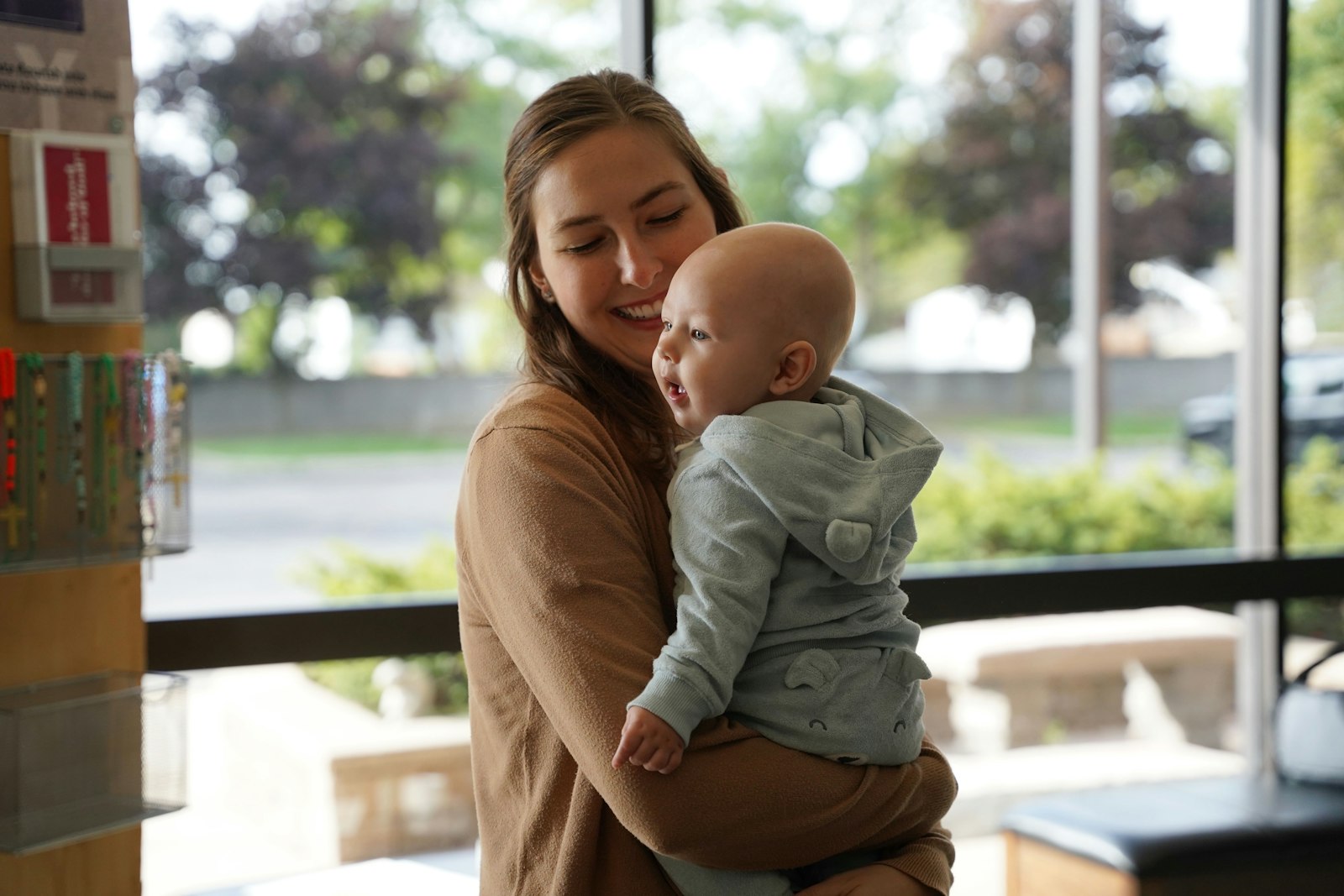 Andrea Spankie holders her five-and-a-half-month-old son, Theo, in the foyer of St. Anastasia.