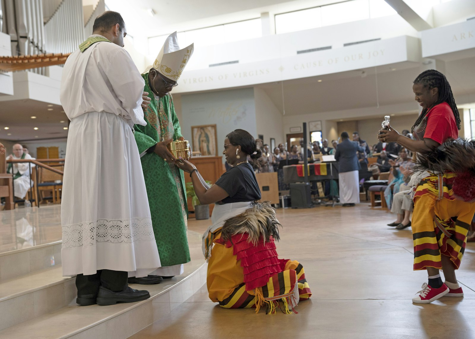 During Mass, the choir sang Ugandan hymns and liturgical dancers (shown in the photo) brought up the gifts.