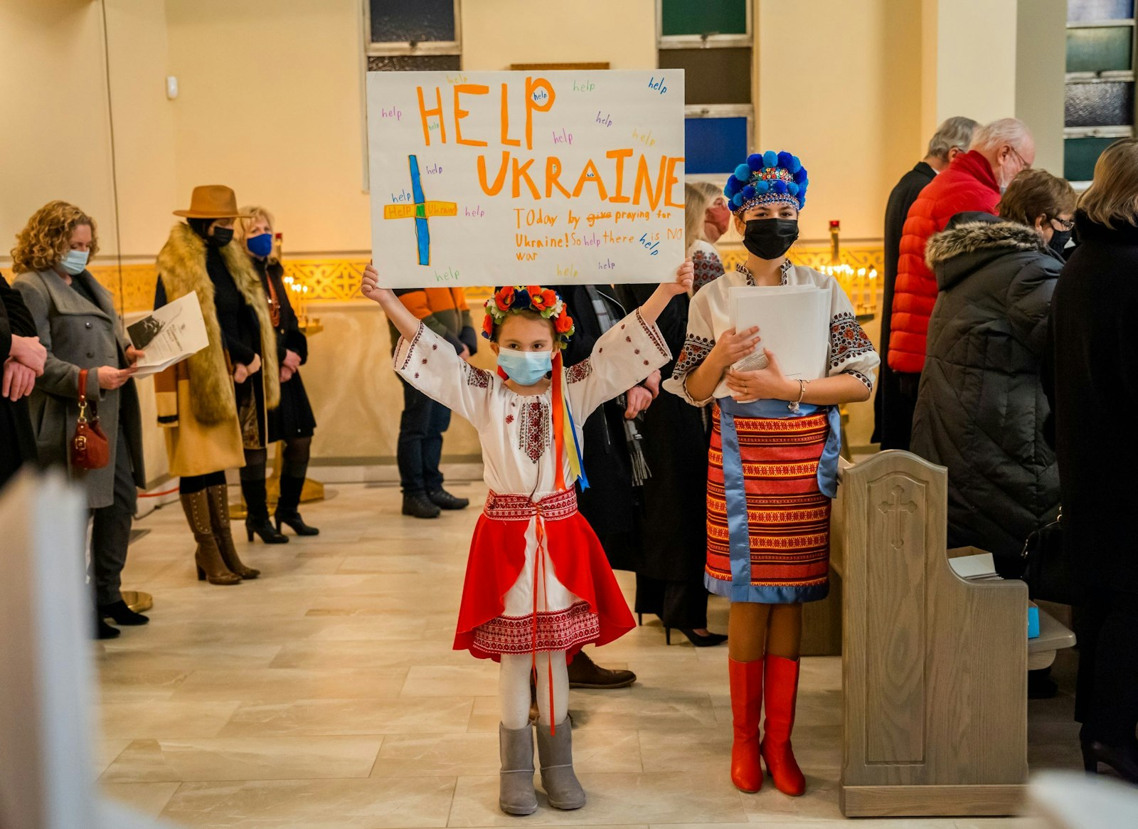 A young girl holds a sign in support of her ancestral homeland. Many local Ukrainians maintain strong ties to the eastern European nation, visiting friends and family often. (Valaurian Waller | Detroit Catholic)