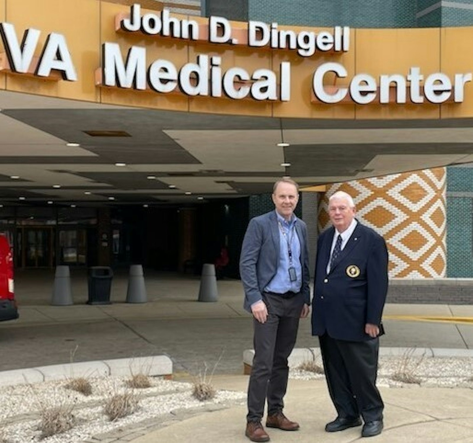 Larry Sulikowski, right, stands with William R. Browning, director of volunteer and community relations for the Veterans Administration, outside the main entrance of the John D. Dingell VA Medical Center in Detroit. (Courtesy photo)