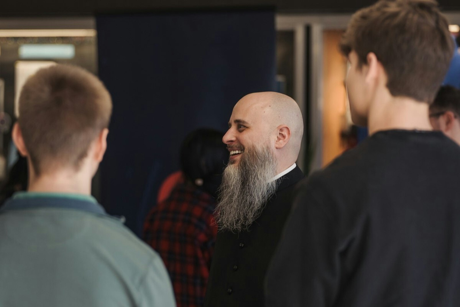 Fr. Giera laughs with students at the annual RISE youth conference in February 2024 at Mercy High School in Farmington. (Leah Butalid | Detroit Catholic)