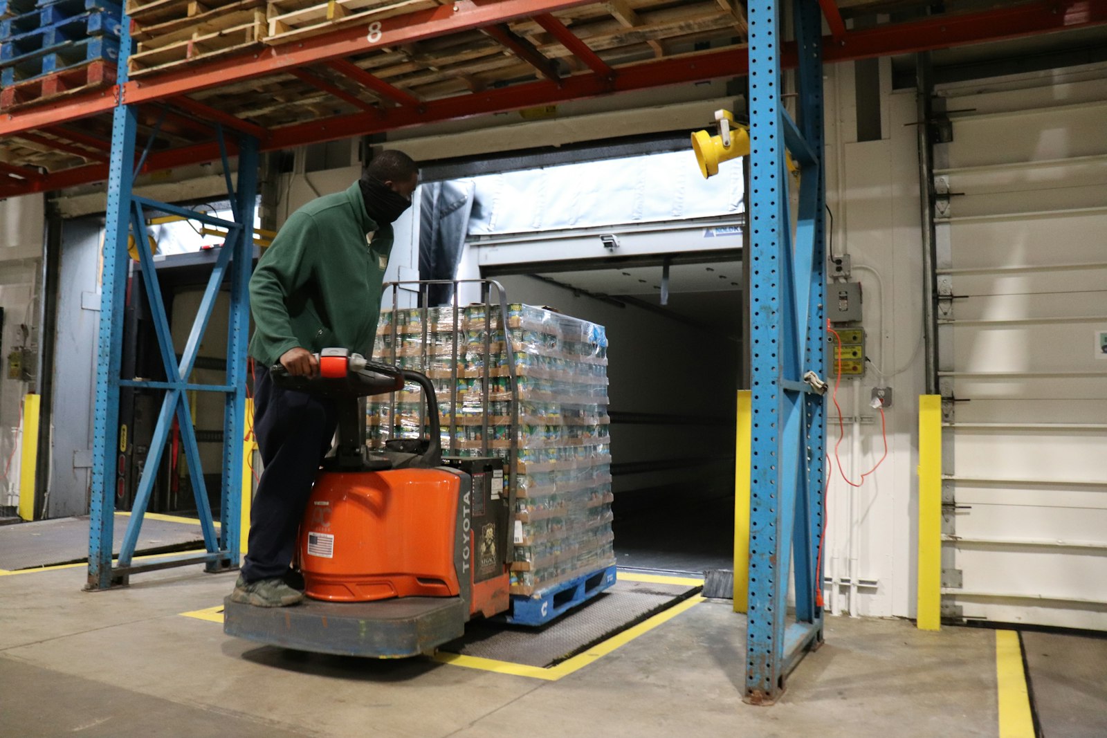 A volunteer loads a pallet of food onto a forklift at Gleaners' warehouse site. While the nonprofit purchases food in bulk from local producers, farms and wholesalers, Gleaners says it projects to spend substantially more this year, even as the need for food remains high two years after the start of the COVID-19 pandemic. (Courtesy of Gleaners Community Food Bank)