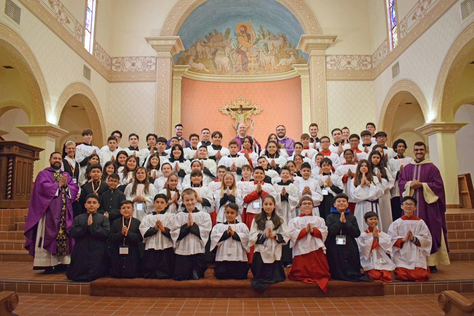 Archbishop-designate Weisenburger is pictured with altar servers and priests following Mass at St. Augustine Cathedral in Tucson. During his episcopate in Tucson, Archbishop-designate Weisenburger has enlisted priests, teachers and parents to foster a culture of discernment in the diocese.