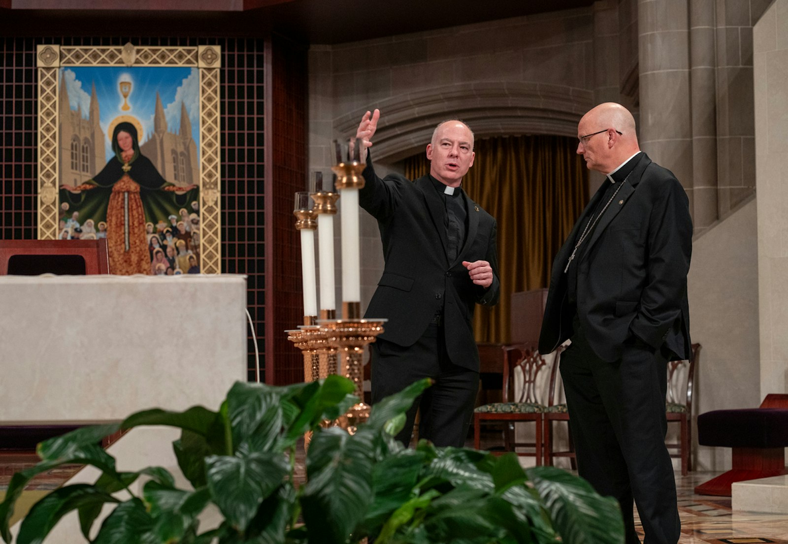 Cathedral rector Fr. J.J. Mech speaks with Archbishop-designate Edward J. Weisenburger with the painting, "Mary, Mother of the Church of Detroit," by local artist Christopher Darga, in the background of the sanctuary of the Cathedral of the Most Blessed Sacrament in Detroit. (Valaurian Waller | Detroit Catholic)