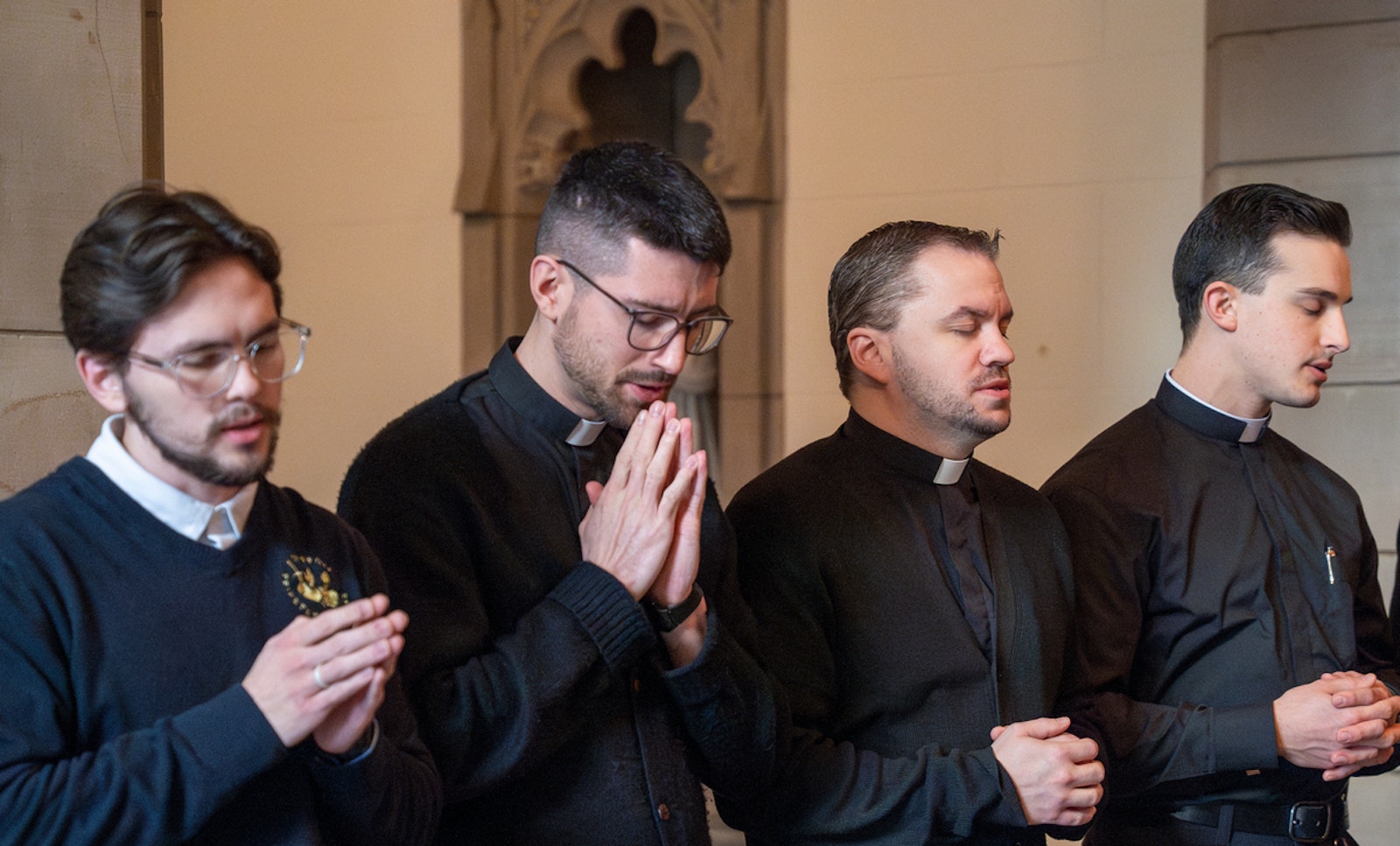 Detroit seminarians pray outside the chapel as they wait for Archbishop-designate Weisenburger to arrive Feb. 11. Before his introductory news conference, Detroit's future archbishop greeted seminarians and encouraged them in their formation.