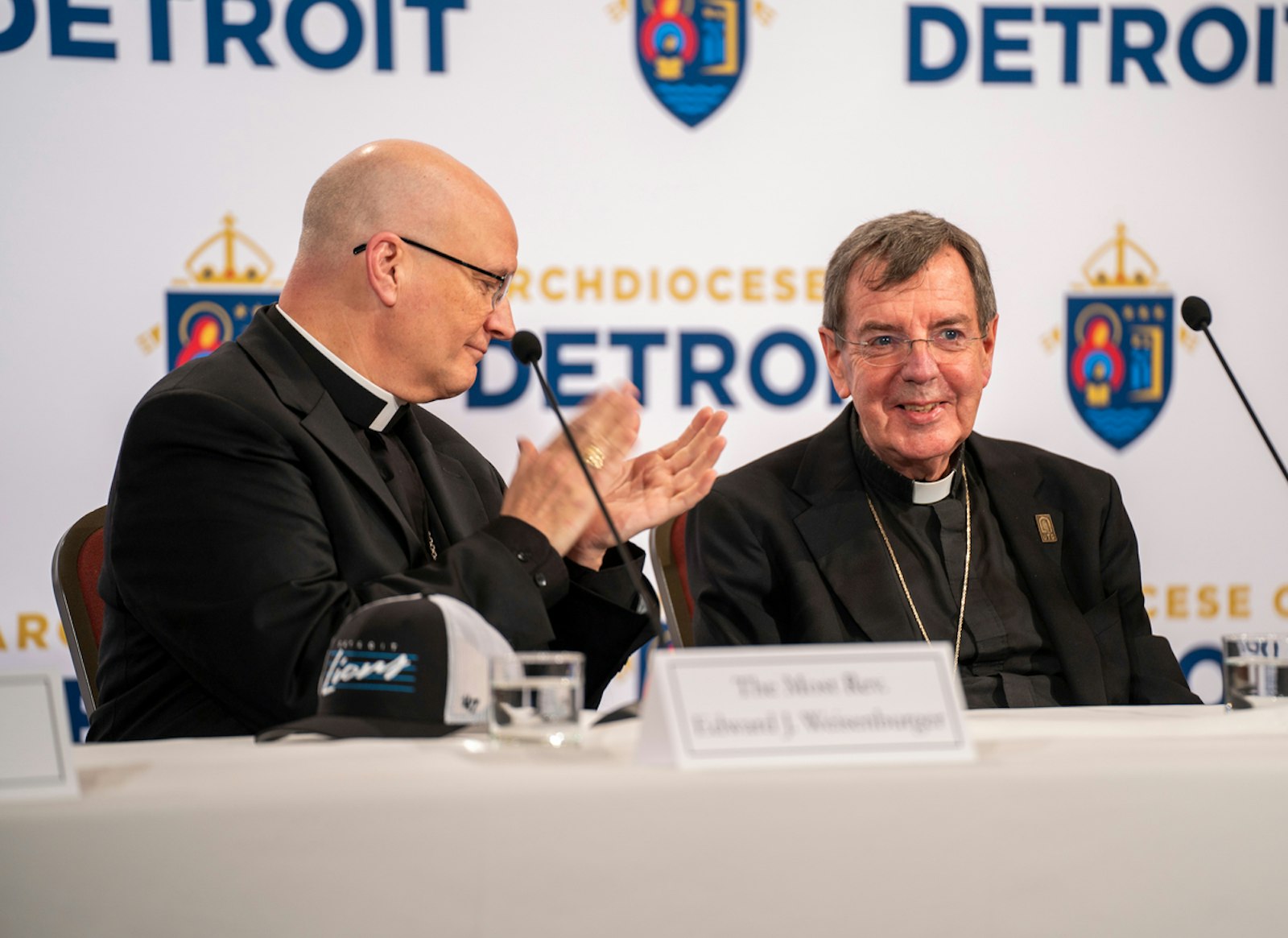 Detroit Archbishop-elect Edward J. Weisenburger leads applause for retiring Detroit Archbishop Allen H. Vigneron, whose leadership of the Archdiocese of Detroit since 2009 has brought many blessings to the local Church, the new archbishop-elect said. Archbishop-elect Weisenburger, who was introduced Feb. 11, 2025, will become Detroit's sixth archbishop during an installation Mass on March 18 at the Cathedral of the Most Blessed Sacrament. (Valaurian Waller | Detroit Catholic)