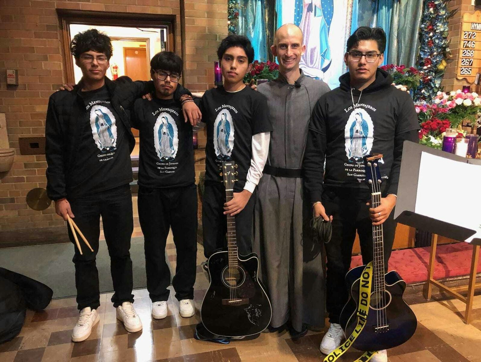Left to right, Juan Pablo Durán, Jordy Durán, Ezequiel, Fr. Jeremy Davis, and Felipe Durán. These four young men are part of the youth group “Los Mensajeros” at St. Gabriel Church. For the past three years, they have been playing in honor of the Virgin of Guadalupe on Dec. 12. “We always try to support them. And these are the things that encourage us to continue; we don’t want the boys to drift away from their faith," explained Esmeralda Durán. (Photo courtesy of Esmeralda Durán)
