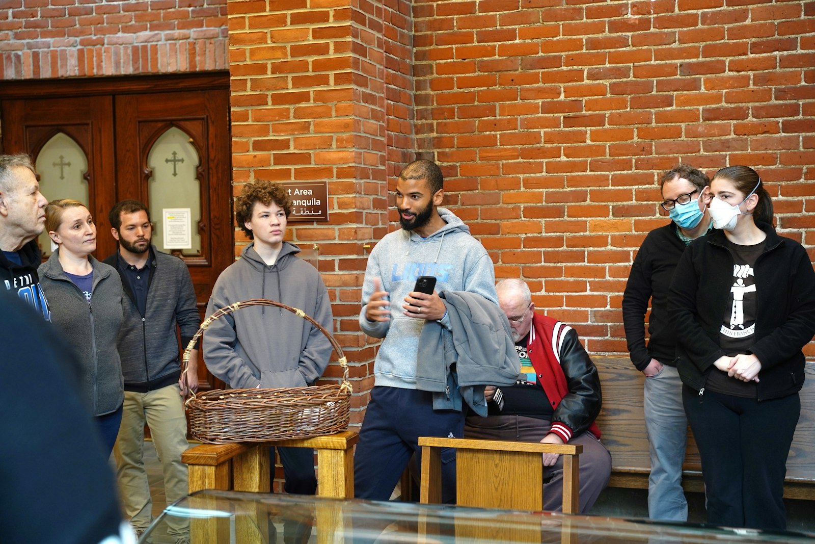 Naim Edwards, a council member for the YouFra Solanus Casey chapter, leads young adults in prayer and meditation at the tomb of Blessed Solanus Casey as part of Simple Service Saturday on Feb. 3.