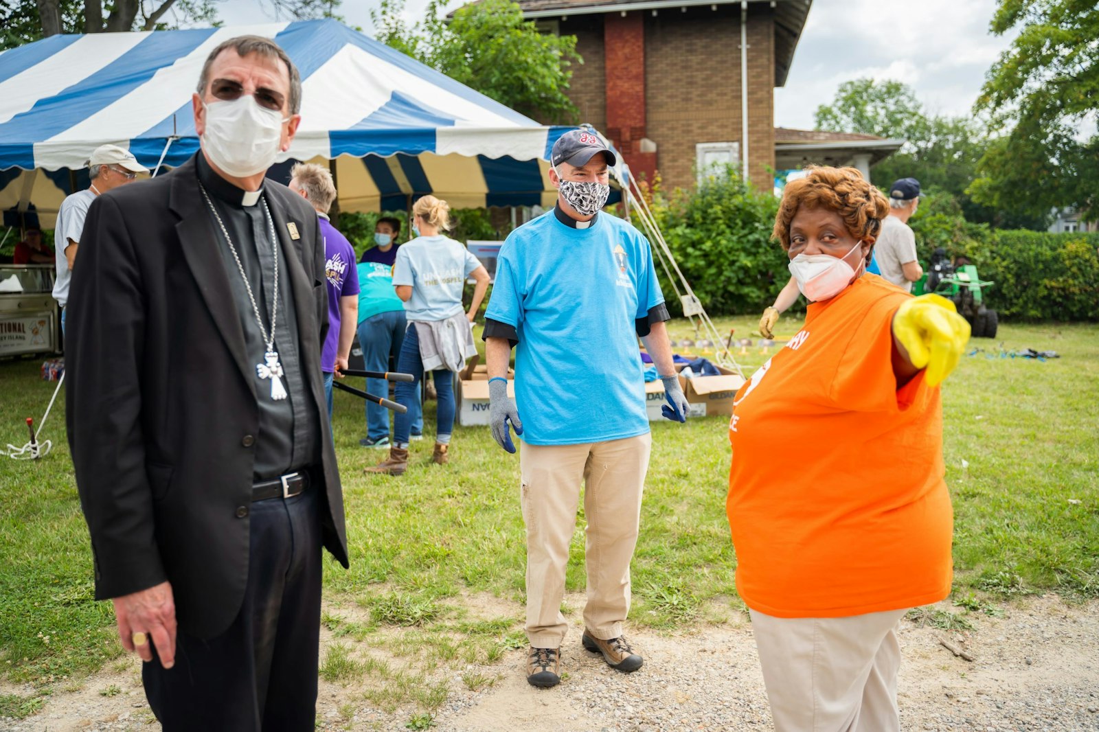 Archbishop Vigneron and Fr. J.J. Mech, rector of the Cathedral of the Most Blessed Sacrament, take part in a neighborhood cleanup day in July 2020, the start of the cathedral's transformation into an "apostolic center for the arts and culture," which would later include several new art installations, outreach to the community and the building of a new low-income housing complex. (Valaurian Waller | Detroit Catholic)