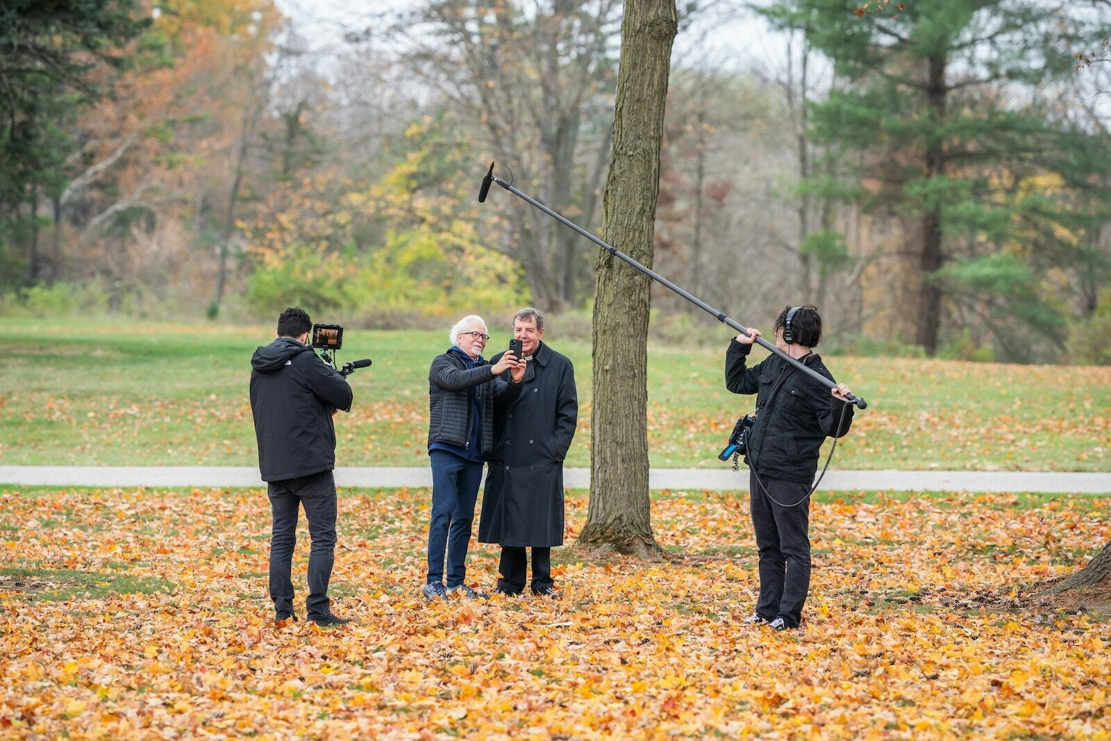 Filmmaker Keith Famie talks with Detroit Archbishop Allen H. Vigneron on the grounds of Holy Sepulchre Cemetery following the All Souls Day Mass on Nov. 2. Famie and his team filmed the Mass for his new project, "Detroit: The City of Faith." (Valaurian Waller | Detroit Catholic)