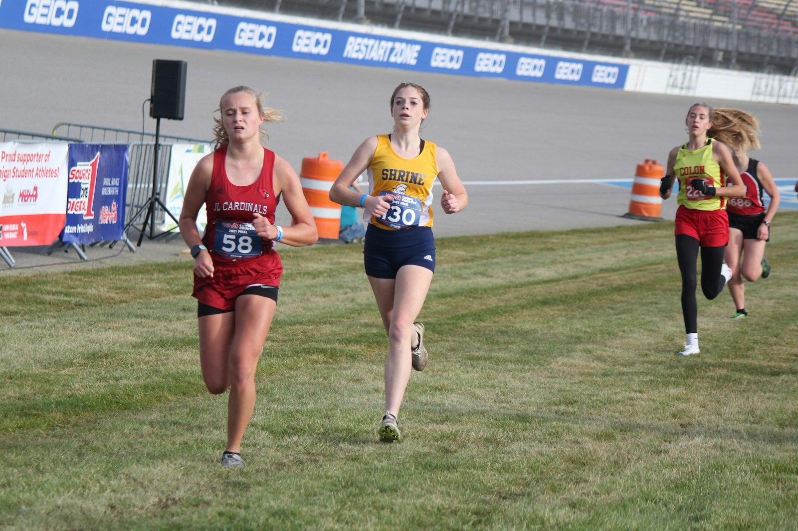 Sprinting toward the finish line, Royal Oak Shrine’s Isobel Malcolm leads her team to an eighth-place finish. Malcolm, who was 63rd, improved her best race time by more than one minute.