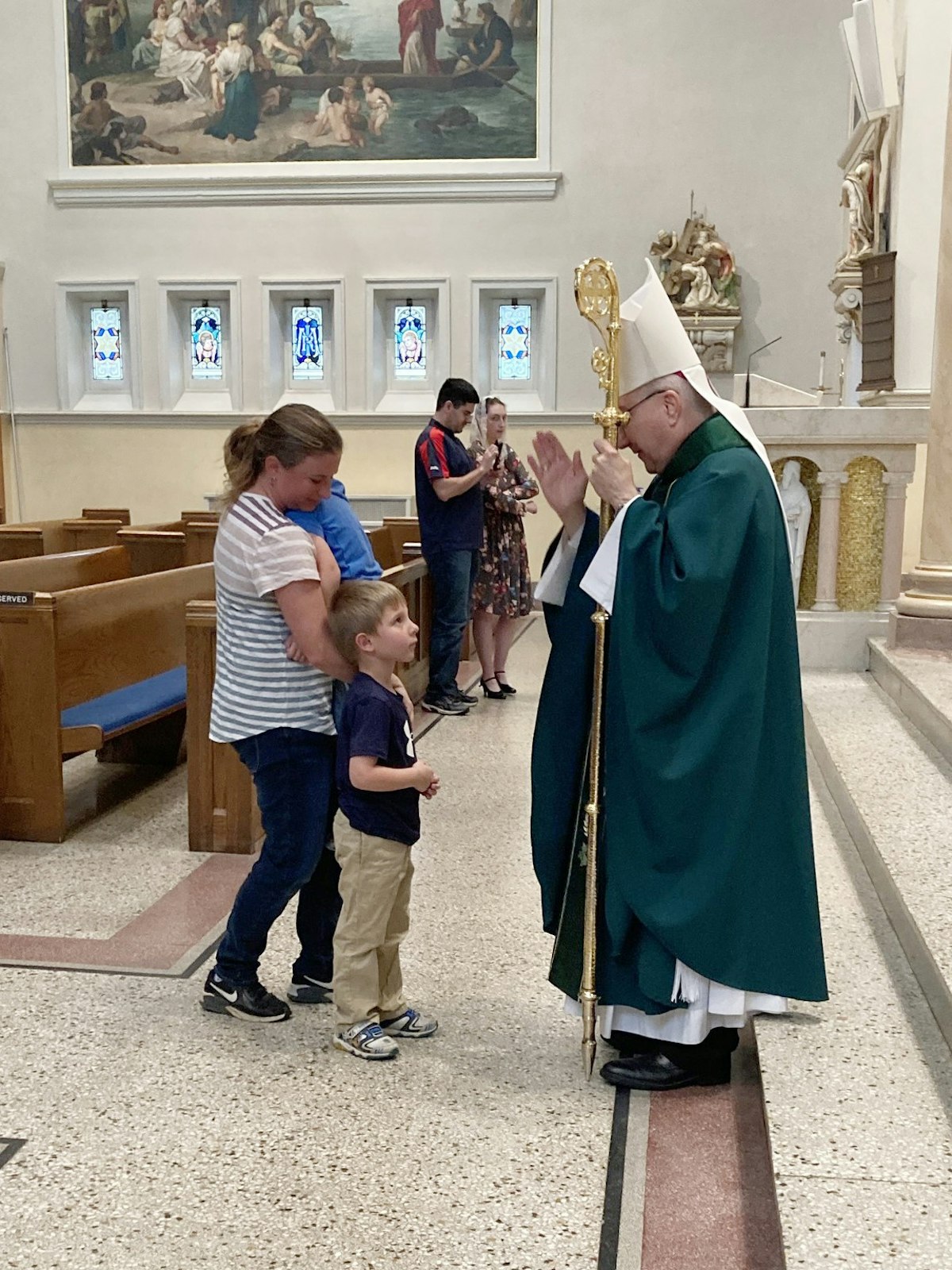 Bishop Monforton blesses a young family during a parish visit in the Diocese of Steubenville. Detroit's new auxiliary bishop said he believes strongly in the value of person-to-person engagement, making a point to visit as many parishes and schools as possible.