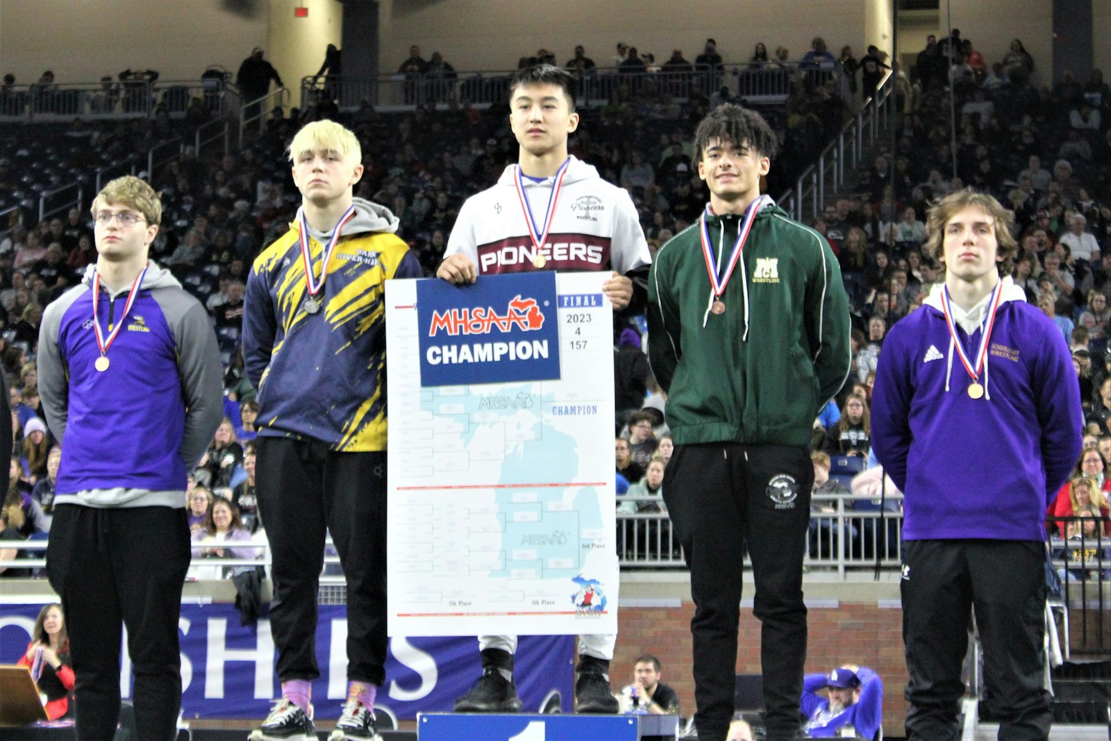 Gabriel Richard sophomore Sebastian Martinez stands on the top rung of the podium after winning the Division 4 157-pound wrestling state championship. He defeated Dillon Raab of Bark River-Harris (to his immediate left) in the final match for the second year in a row.