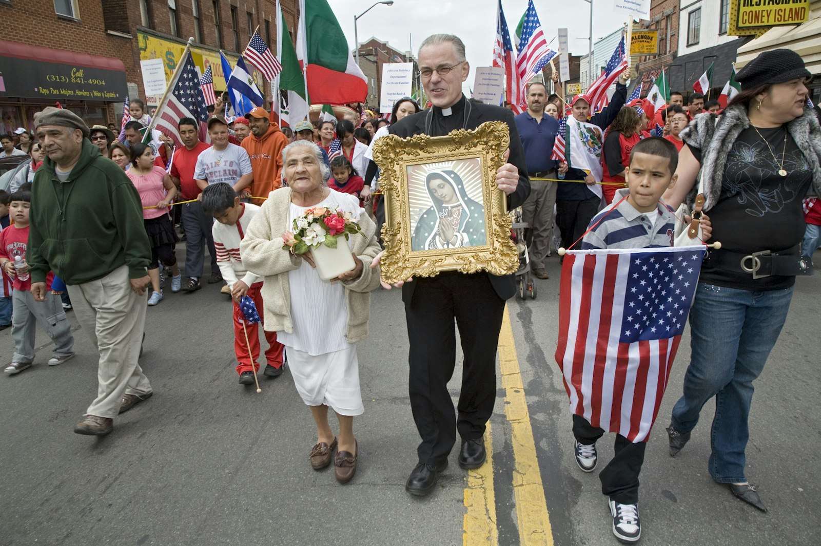 Then-Msgr. Donald Hanchon holds an image of Our Lady of Guadalupe as he marches with other protesters during a May 2007 immigration rally in downtown Detroit. Msgr. Hanchon joined thousands of demonstrators in the heavily Hispanic neighborhood, demanding legal rights for illegal immigrants. (Jim West | Detroit Catholic file photo)