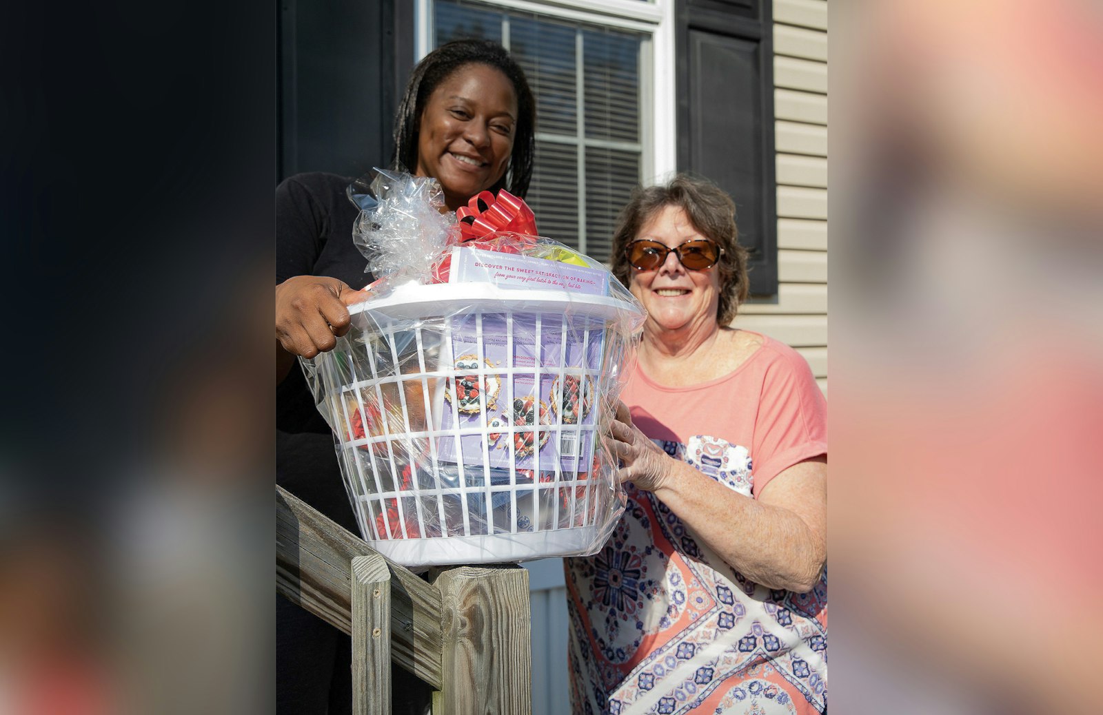 Volunteers with St. Vincent de Paul's Journey to Housing program help a beneficiary move into her new home.