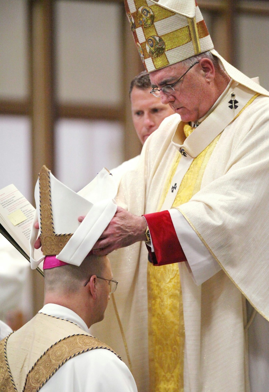 Archbishop Joseph F. Naumann of Kansas City places the miter atop then-Bishop Weisenburger’s head during the latter’s episcopal consecration and installation as the 11th bishop of Salina, Kansas, on May 1, 2012, at the Cathedral of the Sacred Heart in Salina. (Photos courtesy of Archbishop-designate Edward J. Weisenburger)