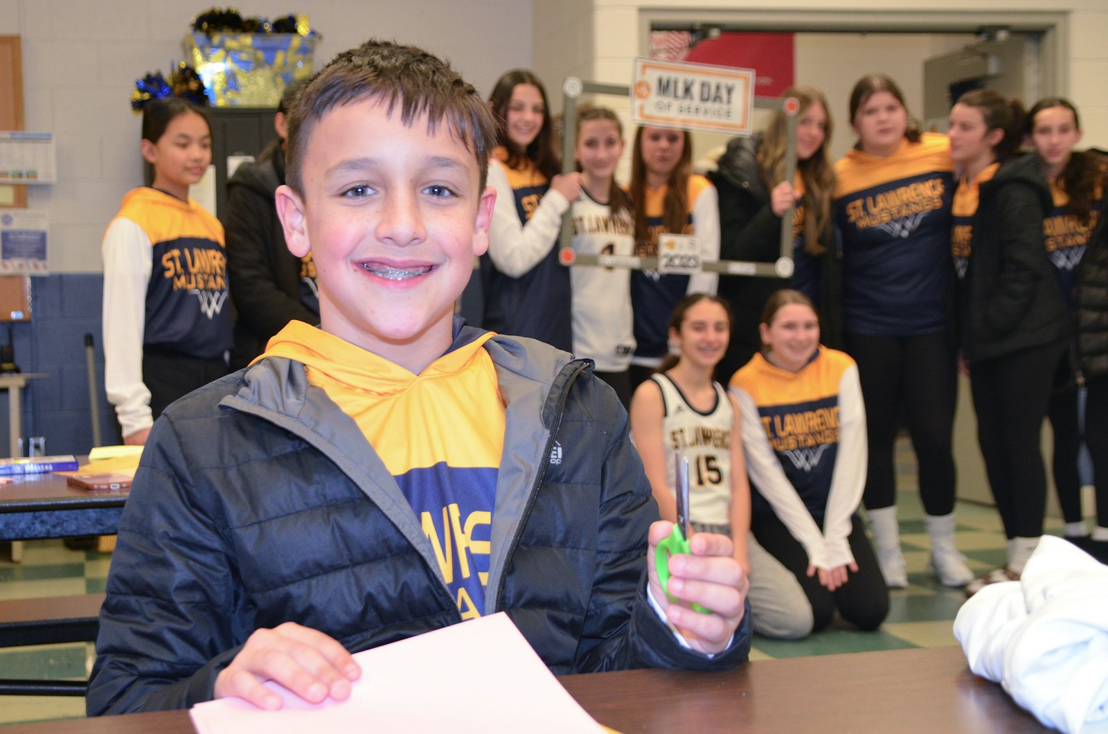 Vincent Newby, a sixth-grader at St. Lawrence Elementary School, prepares to write a prayer on the cross he creates.