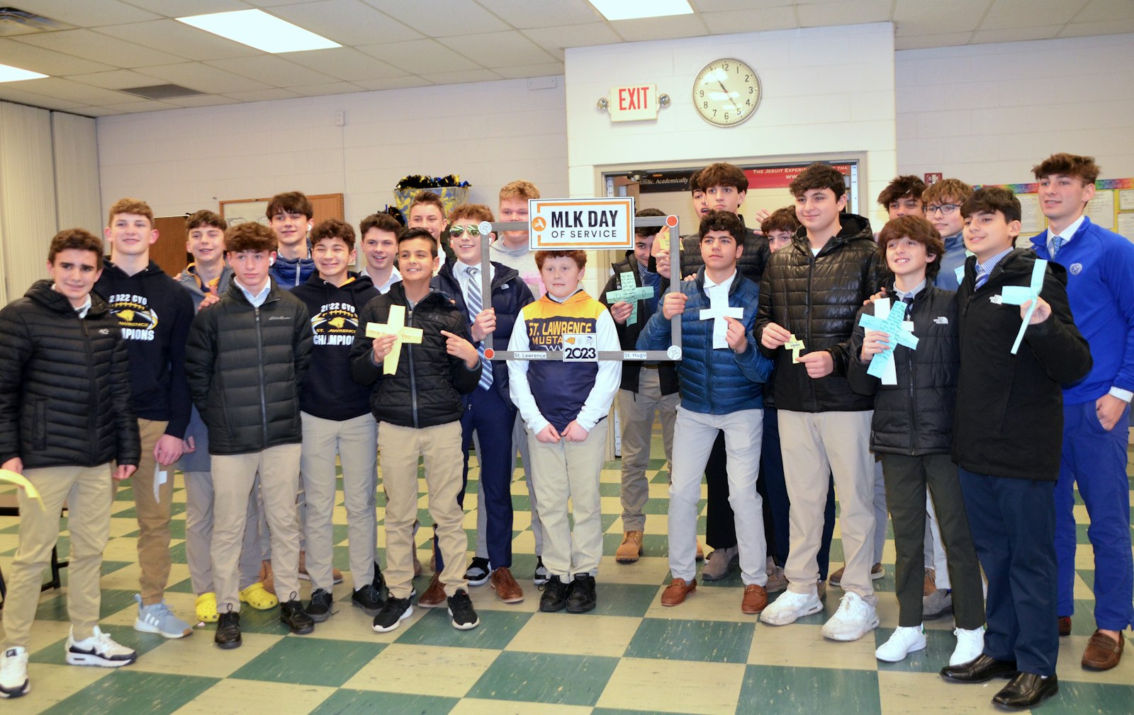 The varsity boys' basketball teams from St. Lawrence (left) and St. Hugo put aside their game-day competition Jan. 14 to gather together as one and write prayers on crosses they designed for a Martin Luther King service project at St. Lawrence Elementary School. The project was led by Jack Novak, youth ministry director at St. Lawrence Parish.