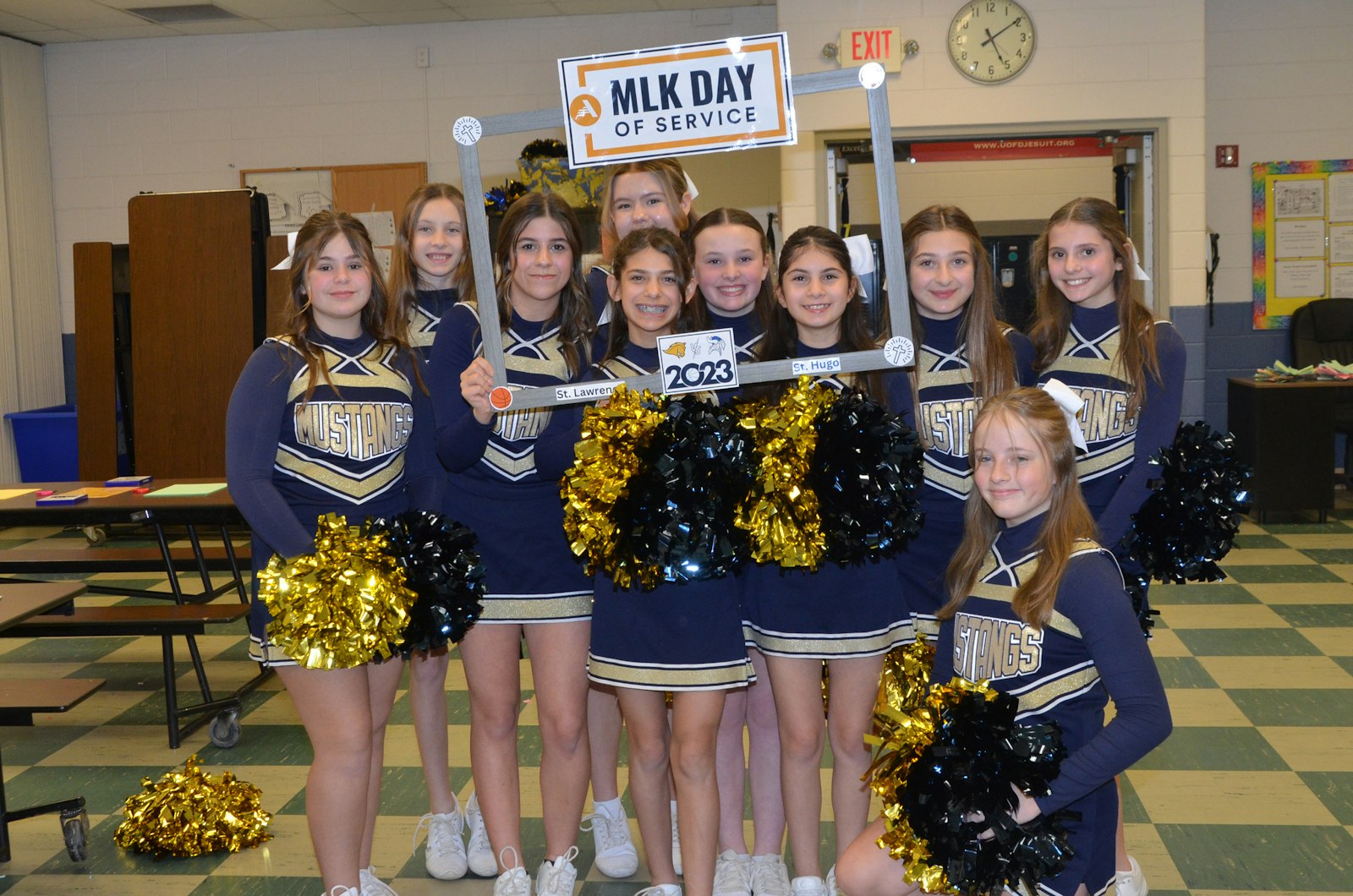 Cheerleaders from St. Lawrence Elementary School pose for a photo after creating and writing prayers on crosses they designed.