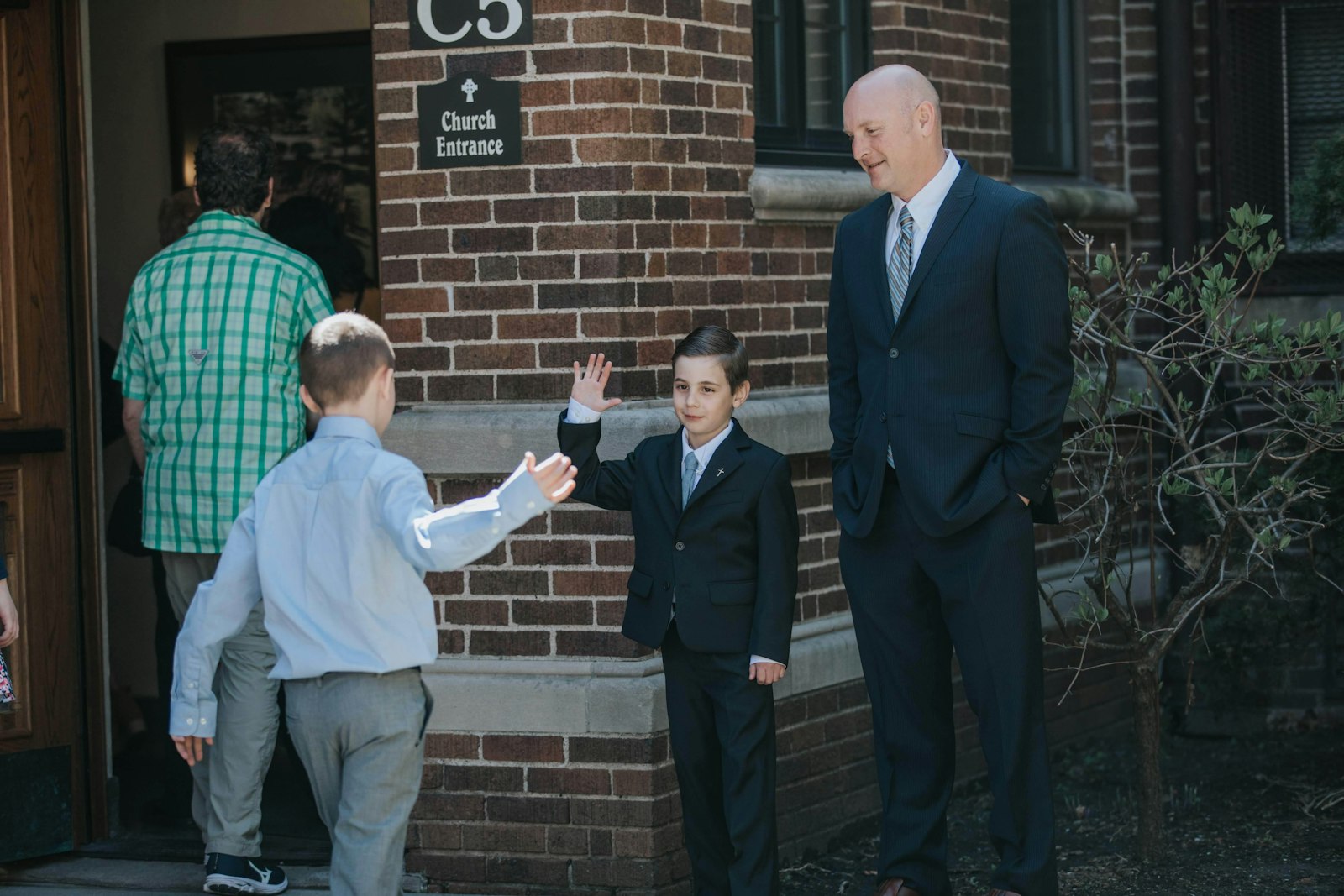 A young man high-fives his classmates as they prepare for their first Communion at Sacred Heart Parish in Dearborn in this file photo. (Naomi Vrazo | Detroit Catholic)