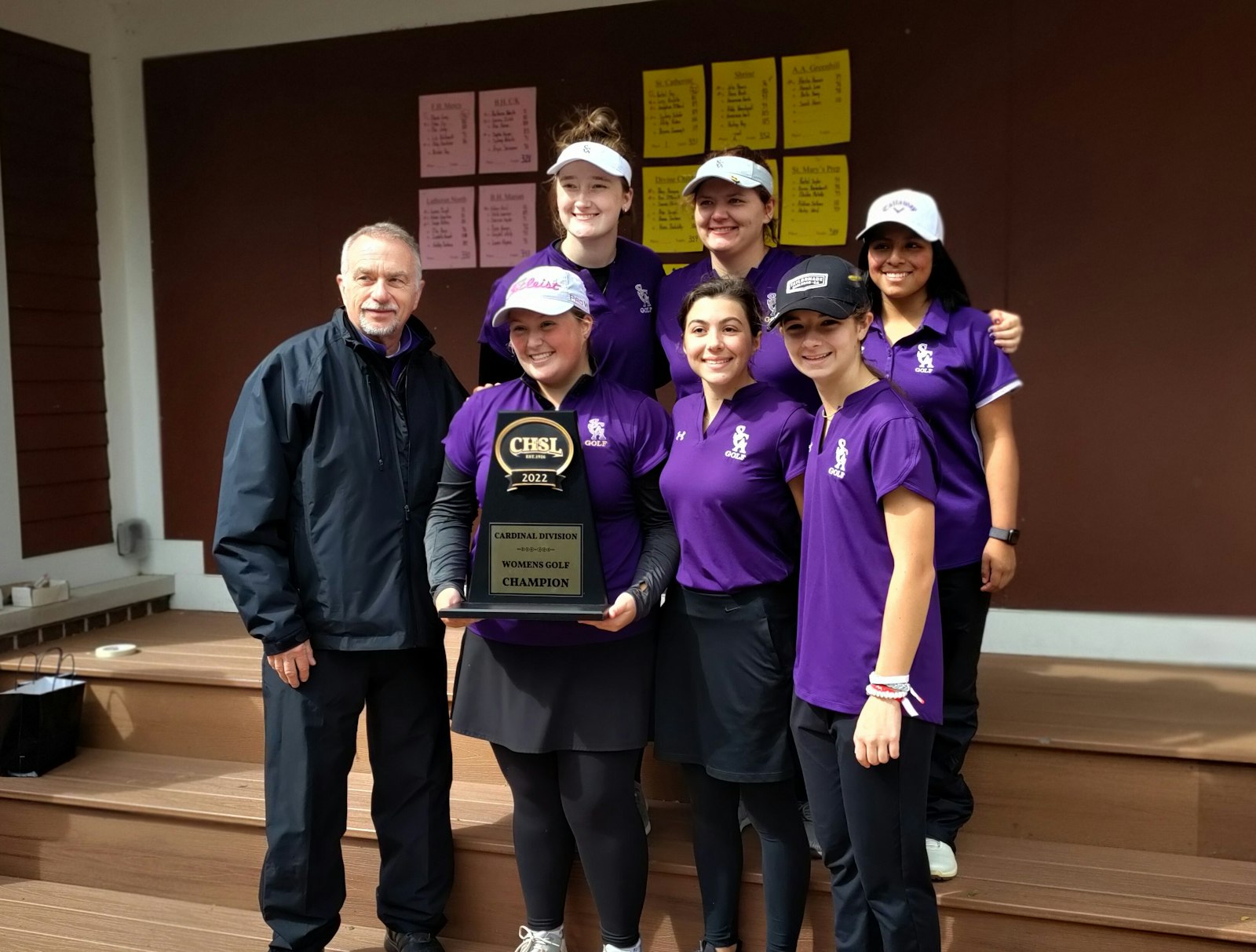 Rachel Fay holds the Cardinal Division trophy, the first Catholic League golf championship for St. Catherine of Siena. Her teammates are Joey McQuaid and Sydney Schafer in the front row, and behind them Brenna Cavanaugh, Abby Raben and Lucy Krichko. Orrin Tibbits has  coached the sport at St. Catherine since its inauguration five years ago.