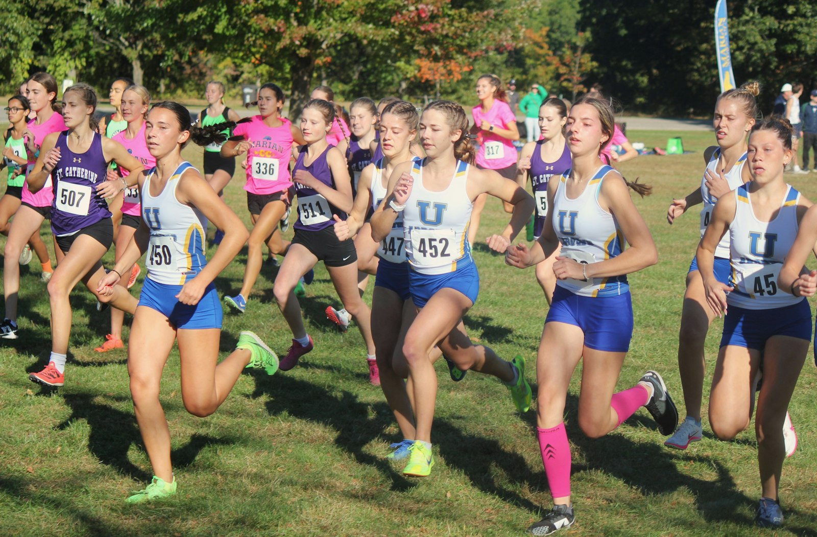 St. Ursula Academy teammates work together in the first half-mile of the championship race. The Arrows won their second straight team championship.