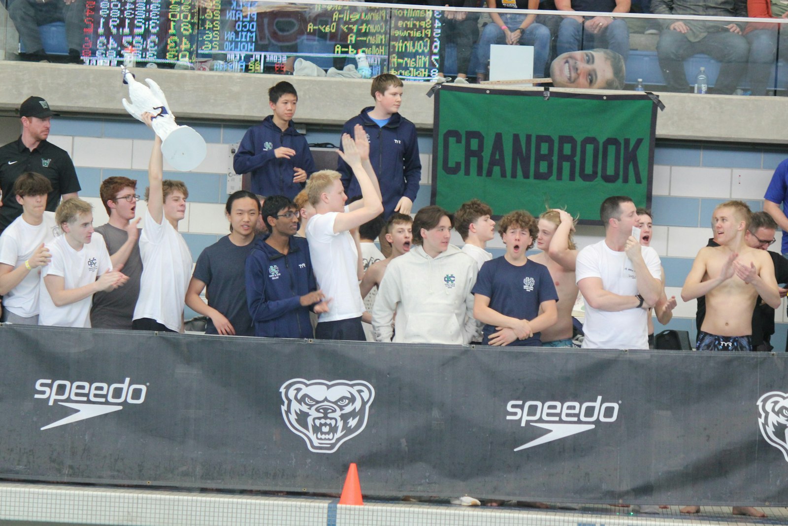 Excited Cranbrook swimmers on the deck watch their team participate in the final event of the afternoon, the 400-yard freestyle relay. The Cranes finished second in the race, preserving their overall championship.