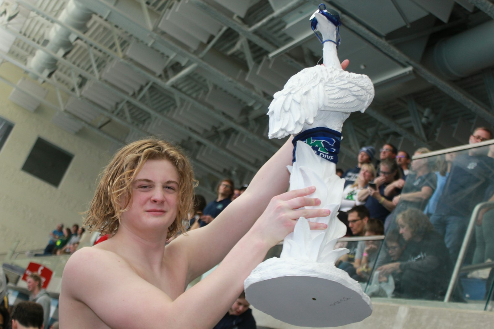 Robbie Sarle gets into the spirit of the meet by showing off the team’s “Crane” statuette, outfitted in Cranbrook colors and swim goggles.