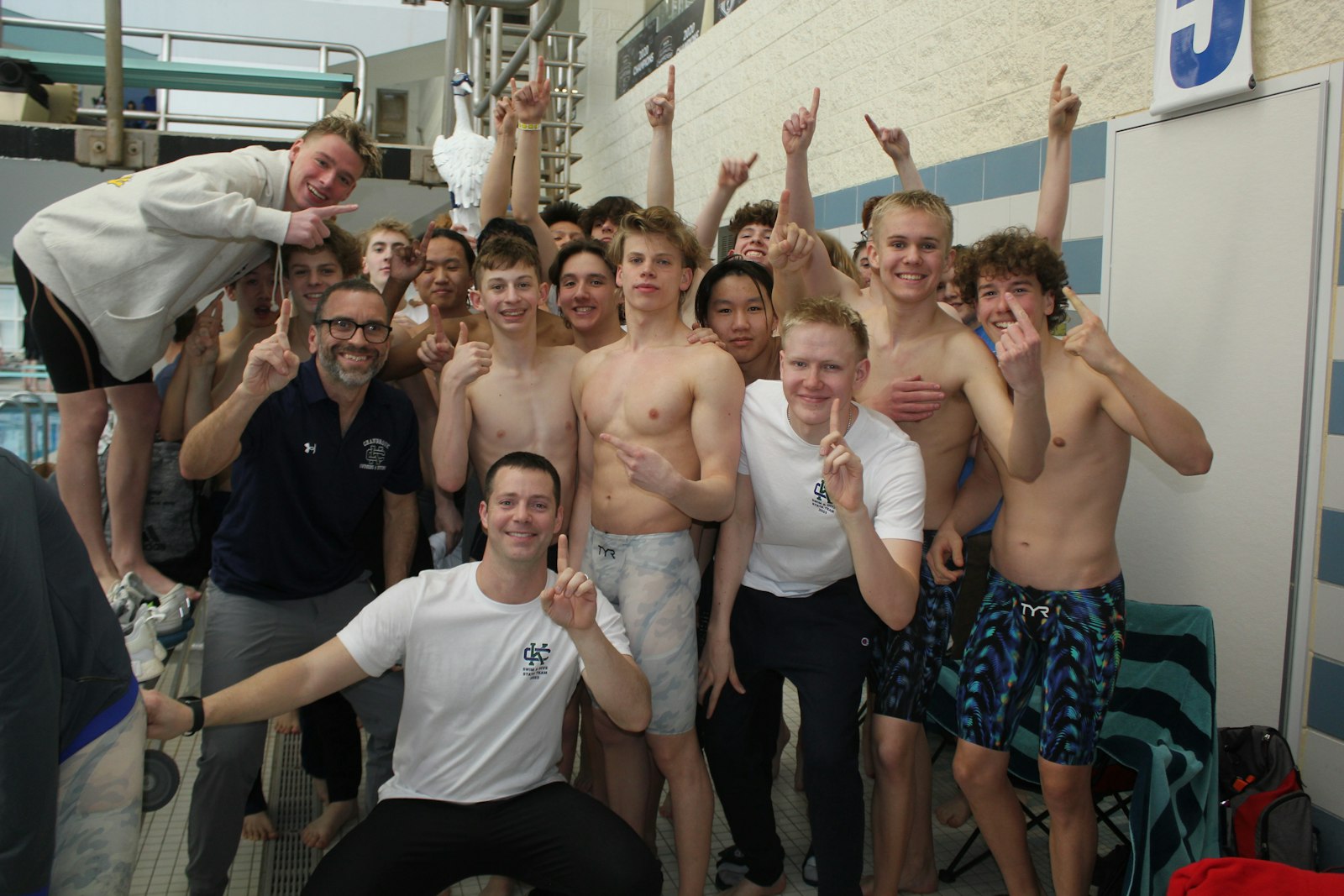 Moments before taking the podium to accept the state championship trophy, Bloomfield Hills Cranbrook-Kingswood’s swimmers celebrate their collective accomplishment. The Cranes narrowly defeated two-time defending champion East Grand Rapids, 271-259.