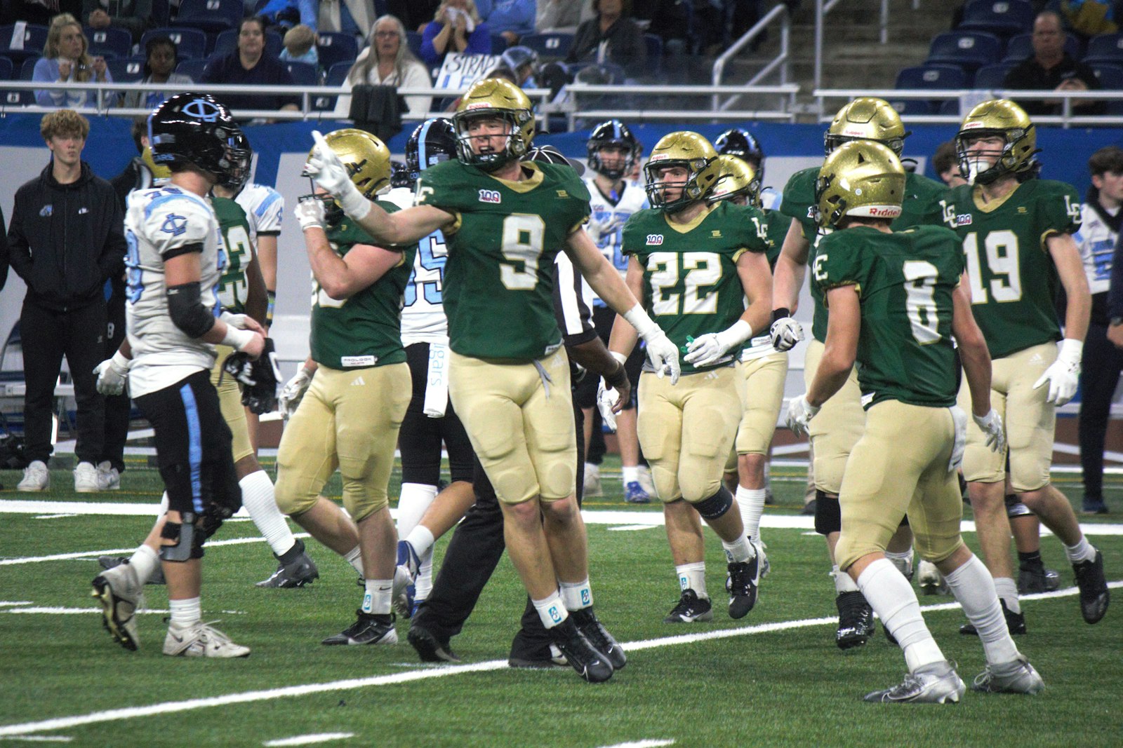 The Lumen Christi defense celebrates after Isaac Rehberg (22) recovered a Lansing Catholic fumble in the first quarter. Rehberg also broke up one pass and blocked an extra point attempt.