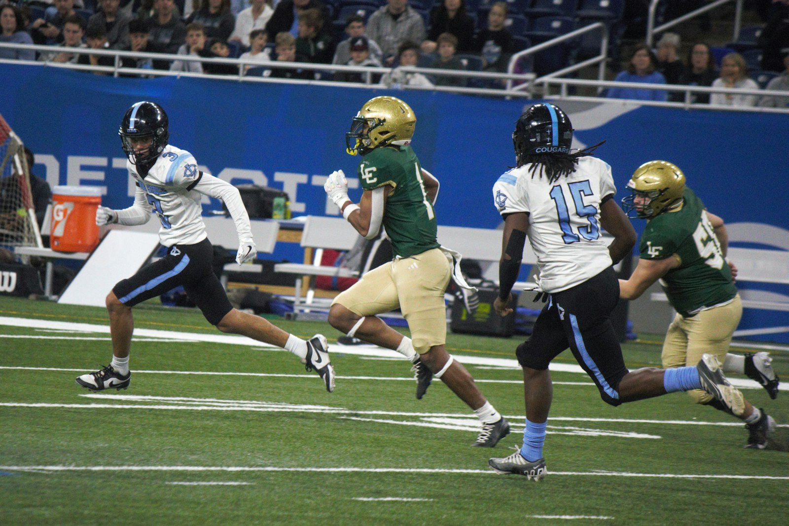 Kadale Williams eludes Lansing Catholic defenders on his way toward the end zone on a 76-yard romp in the second quarter. He rushed for five touchdowns, topping the three he scored in the 2023 championship win over Menominee.