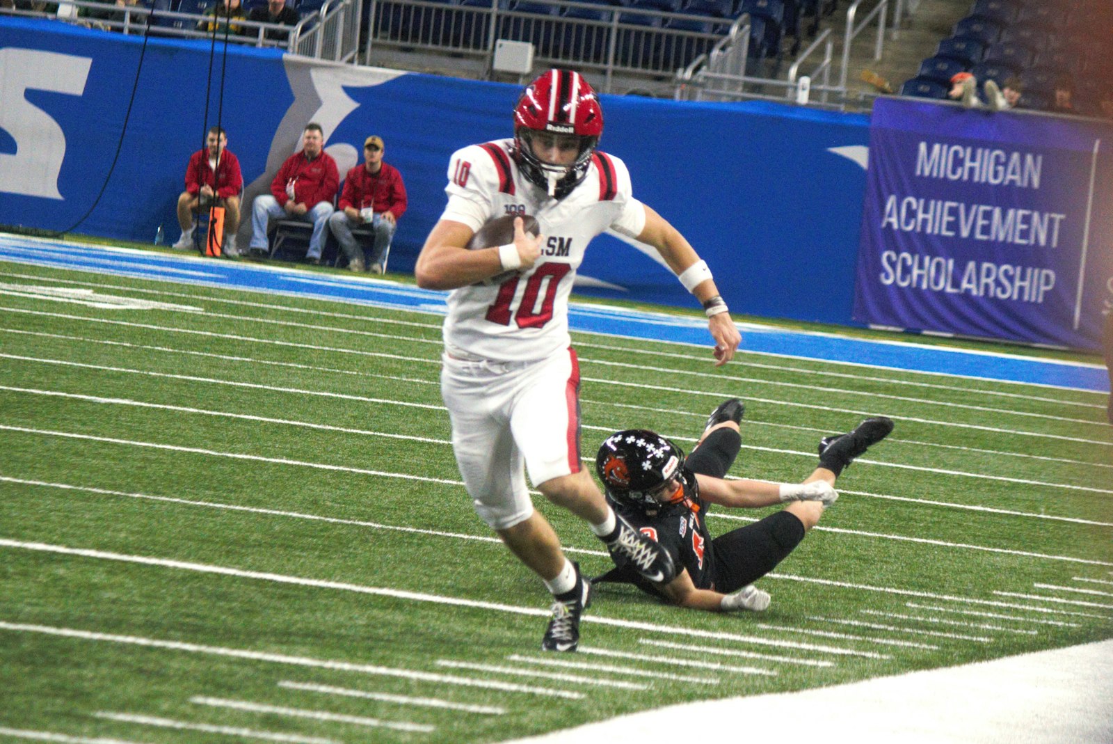 Quarterback Axel Newell turns upfield after scrambling away from a Byron Center defender. Newell threw a touchdown pass to Angelo Chapman during St. Mary’s 35-19 victory in the state championship game.