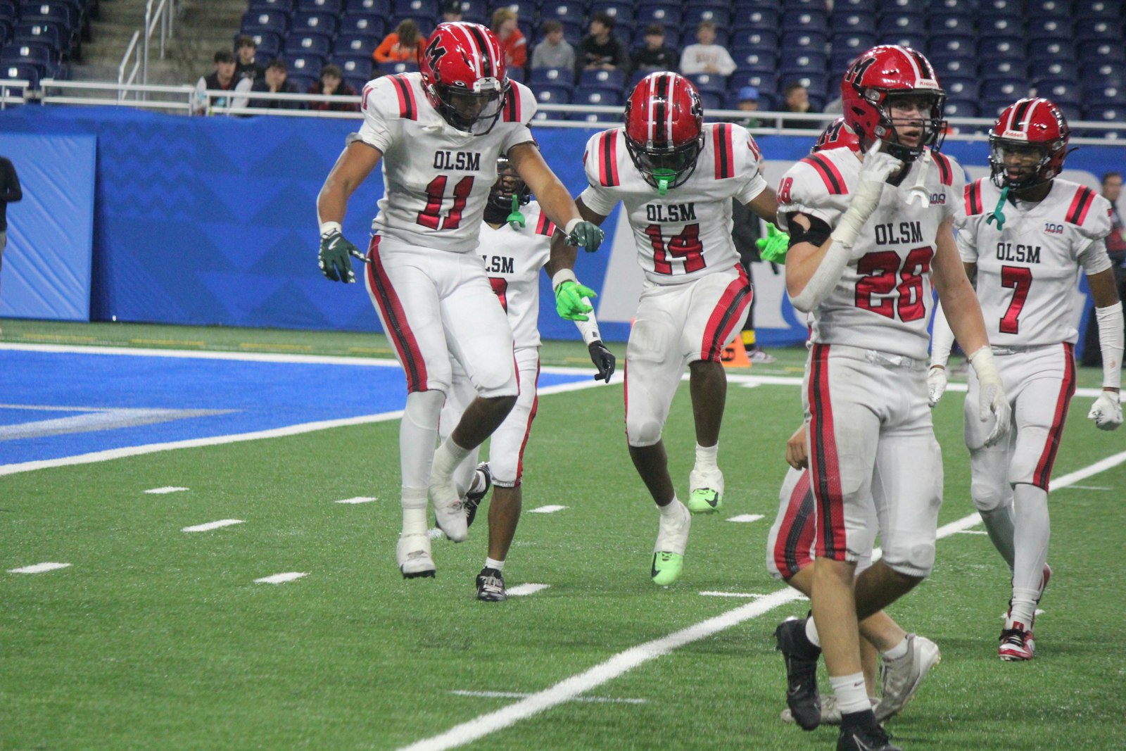 Charles “DJ” White (11) and Camari Patterson (14) jump for joy after Patterson knocked away at Byron Center fourth-down pass attempt late in the game.