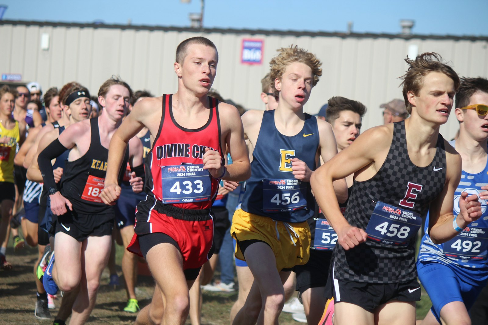 Dearborn Divine Child senior Colin Murray (1433) looks to move up through the pack, going around the first turn of the Division 2 boys’ championship race. Murray eventually finished fourth.