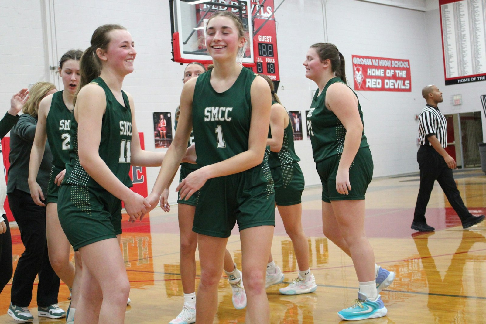 Monroe St. Mary Catholic Central players celebrate a come-from-behind road victory at Grosse Ile on Thursday night. Adela Illes (1) led the team with 18 points in the 36-32 win.