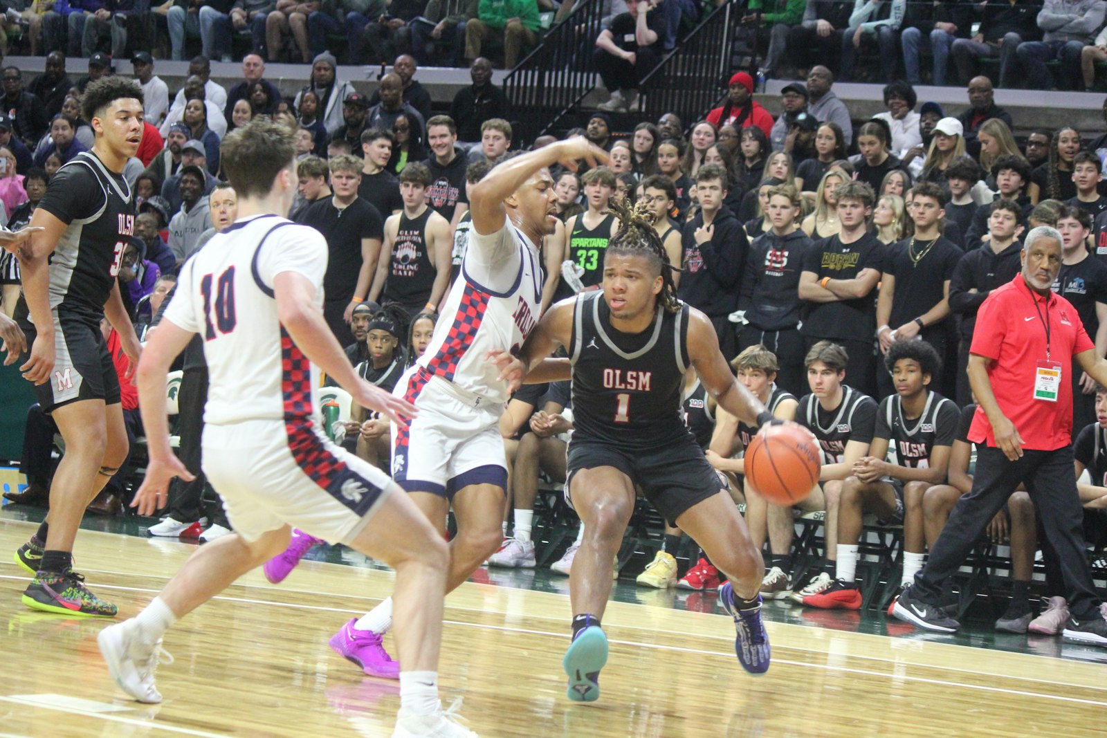 Eaglet senior Trey McKenney looks for an open route to the basket. The University of Michigan commit had a game-high 21 points but couldn’t overcome East Lansing, 51-44, at Michigan State University’s Breslin Center on Friday afternoon.